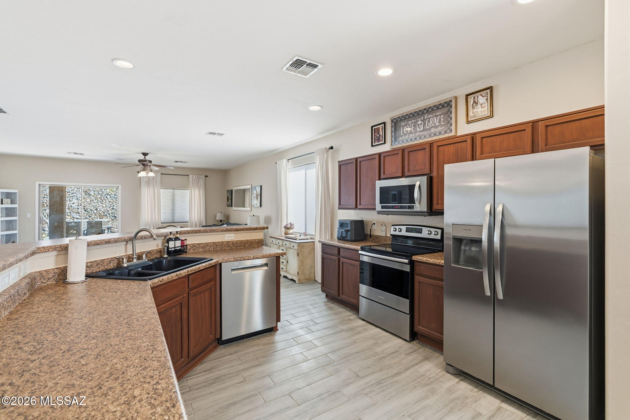 Assumable loan may be available at 2.25%--subject to lender approval and buyer qualification. Move-in ready 3BD/2BA home in desirable Santa Rita Ranch in Vail. 1,789 sq ft open-concept split floor plan with formal dining, spacious great room, and excellent natural light. Oversized kitchen offers abundant counter space and prep room, large breakfast bar, walk-in pantry, plumbed for gas cooking, Bosch dishwasher, and included refrigerator. Laundry off kitchen includes washer/dryer. Tile in main living areas. Primary suite w/ dual sinks, separate shower, garden tub, and walk-in closet. Covered patio + pavers, low-maint turf yard. Perfect setup for easy indoor/outdoor entertaining. 2024 heat pump HVAC, 2022 gas water heater. Oversized 2.5-car garage + 3 driveway spots. Low HOA $34/month.