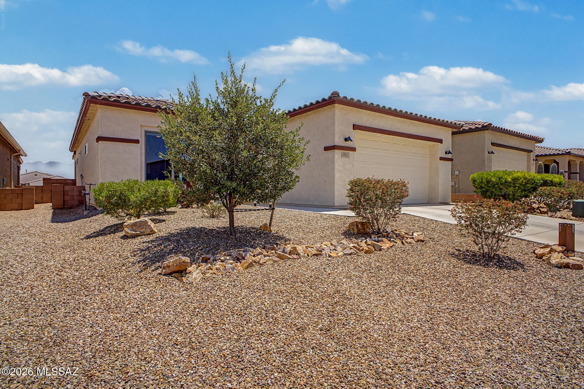 Welcome to this custom Fairfield-built, single-level home in Las Campanas, offering a rare 3-bedroom, 2-bath floor plan with 1,604 sq ft of thoughtfully designed living space, custom upgrades, and a functional, low-maintenance lifestyle. Nestled on a single-loaded street, the home also enjoys partial Santa Rita Mountain views. The sun-filled, open-concept layout creates a warm and inviting atmosphere, with every detail carefully considered. Stunning porcelain tile flows throughout the home, with no carpet, providing a seamless and elegant look.
Custom features include a Murphy bed in the third bedroom and built-in entryway shelving with concealed shoe storage for added convenience. Every space reflects quality craftsmanship and thoughtful design, making this home truly stand out. As part of the Green Valley Recreation network, you'll enjoy access to an extensive collection of recreation centers, fitness facilities, clubs, social activities, and leisure opportunities. This exceptional home is ready to impress--welcome home!