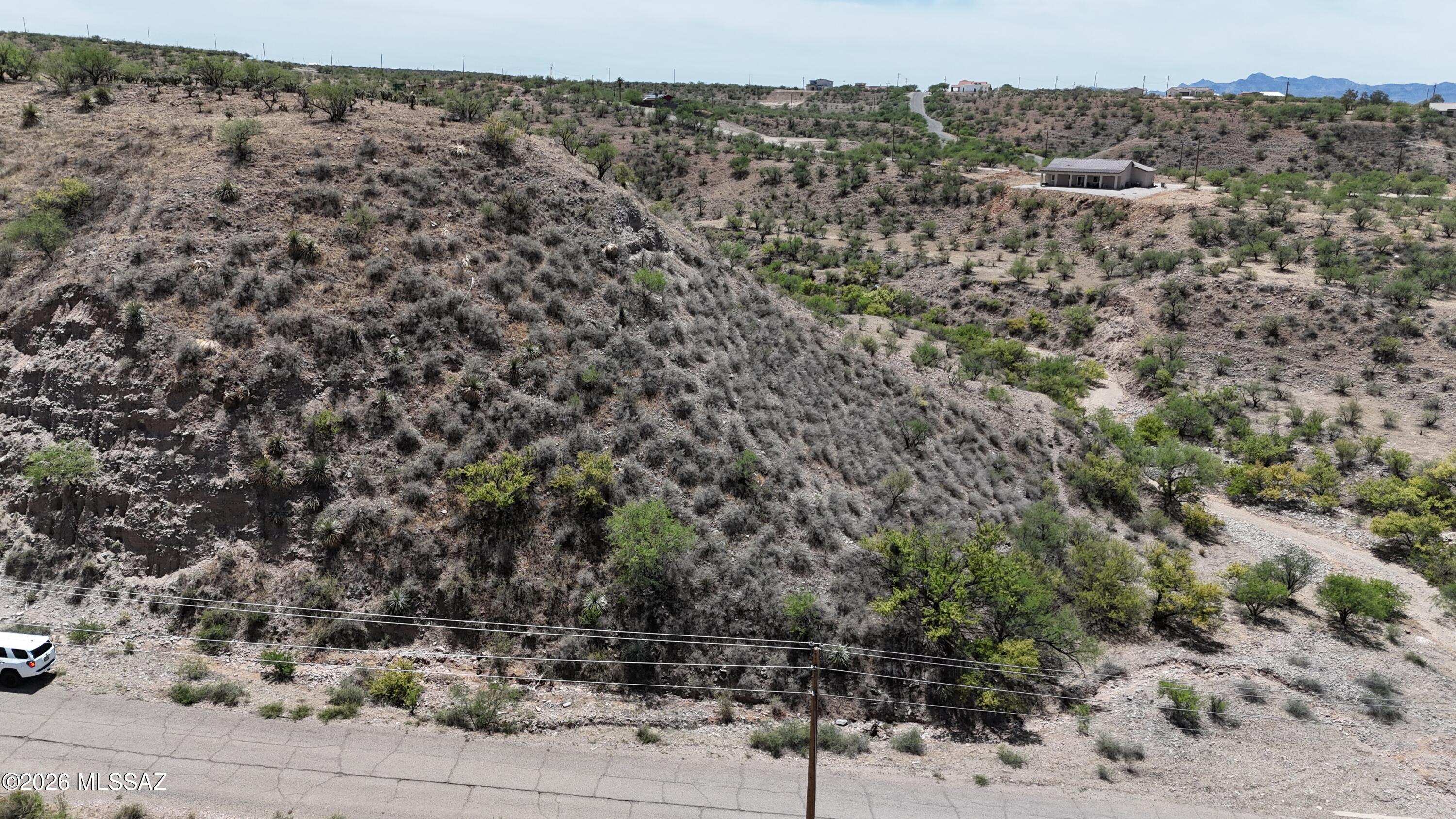 Build your home on a hilltop without having to climb the hill.  This lot has fairly level access that leads out to the end of a bluff with stunning views. I saw a metal box at the end of the street which tells me there is a water line and there are also power poles at the street.
