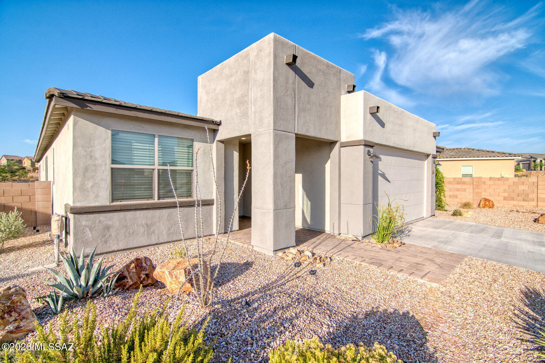 Here is a fantastic opportunity for your next home! This gated, 4 bedroom eastside home is a former model and is almost brand new!  It comes with all the upgrades (170K)) that model homes feature and is truly special.  A gorgeous kitchen features a gas cooktop, ENERGY STAR appliances, an island with a granite countertop and beautiful cabinets.   12 foot sliders in the great room add light and the open feel giving views to the backyard and green space.  The large primary suite includes a giant walk-in shower, double vanities and a walk-in closet. The split bedroom plan home includes a wonderful separate guest suite with a full bath, and large closet.  (Continued) A dedicated office space with french doors, laundry room, third full bath and two additional guest bedrooms complete the home.  The garage with epoxy floors is extra large with space for exercise equipment or hobbies.  Ceiling fans everywhere, a north south orientation, and Energy Star Qualifications make this home comfortable and efficient.  The larger lot is completely landscaped with beautiful plants, a view of the large greenspace. artificial grass and a large built in barbecue.  Come see this home, you will love it!