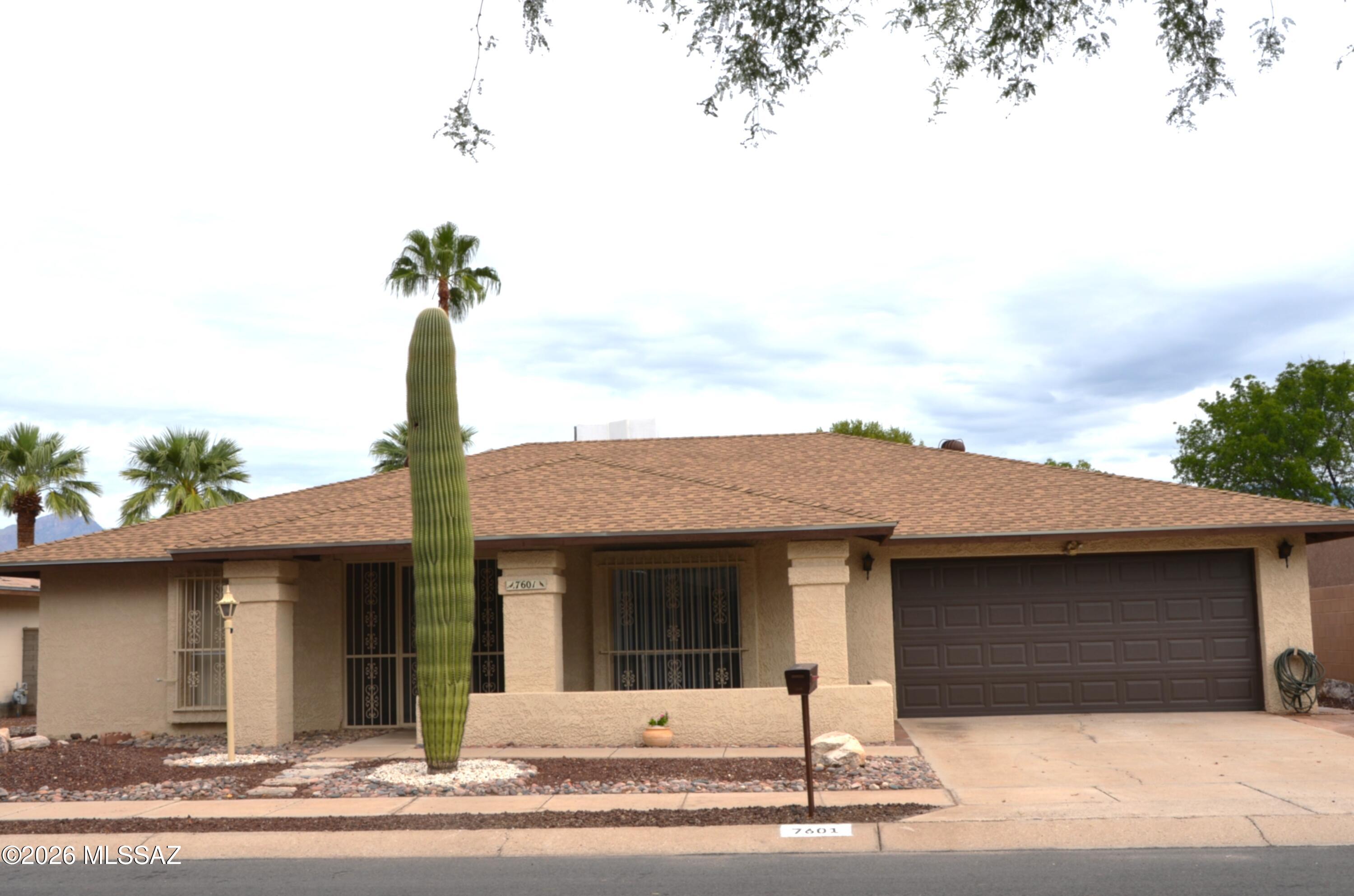 Welcome to your desert oasis in the highly desirable Vista Del Rio Subdivision. This open and spacious 3-bedroom, 2 Bathroom home perfectly blends southwestern charm with modern comfort, Enjoy mountain views from your private backyard pool and spa, or relax in a large, screened-in Arizona Room. Inside, a large step-down living room and formal dining room offers excellent space for entertaining, while the cozy family room off of the kitchen features a classic Beehive fireplace. The bright Master Bedroom boasts a private spa access, a sunken bath shower, general walk-in closet and dressing room. Easy-care ceramic tile and cooling ceiling fans throughout home . Front Exterior: Low-maintenance desert landscape featuring a beautiful lone Saguaro cactus, a brick patio and enclosed atrium welcoming you to the front door. Backyard. Built in gas line BBQ hook-up mature shade, orange, olive tree. New Roof (2026) newly replaced automatic garage door. Spacious 2-car garage complete with a built-in workbench. Skylight in hallway bathroom, wired hallway path lights, and a hard wired intercom/radio system including AZ RM. Clean and Crisp and move in ready. Appliance Included, Refrig, DW, Stove/Oven, Microwave, Washer/Dryer.