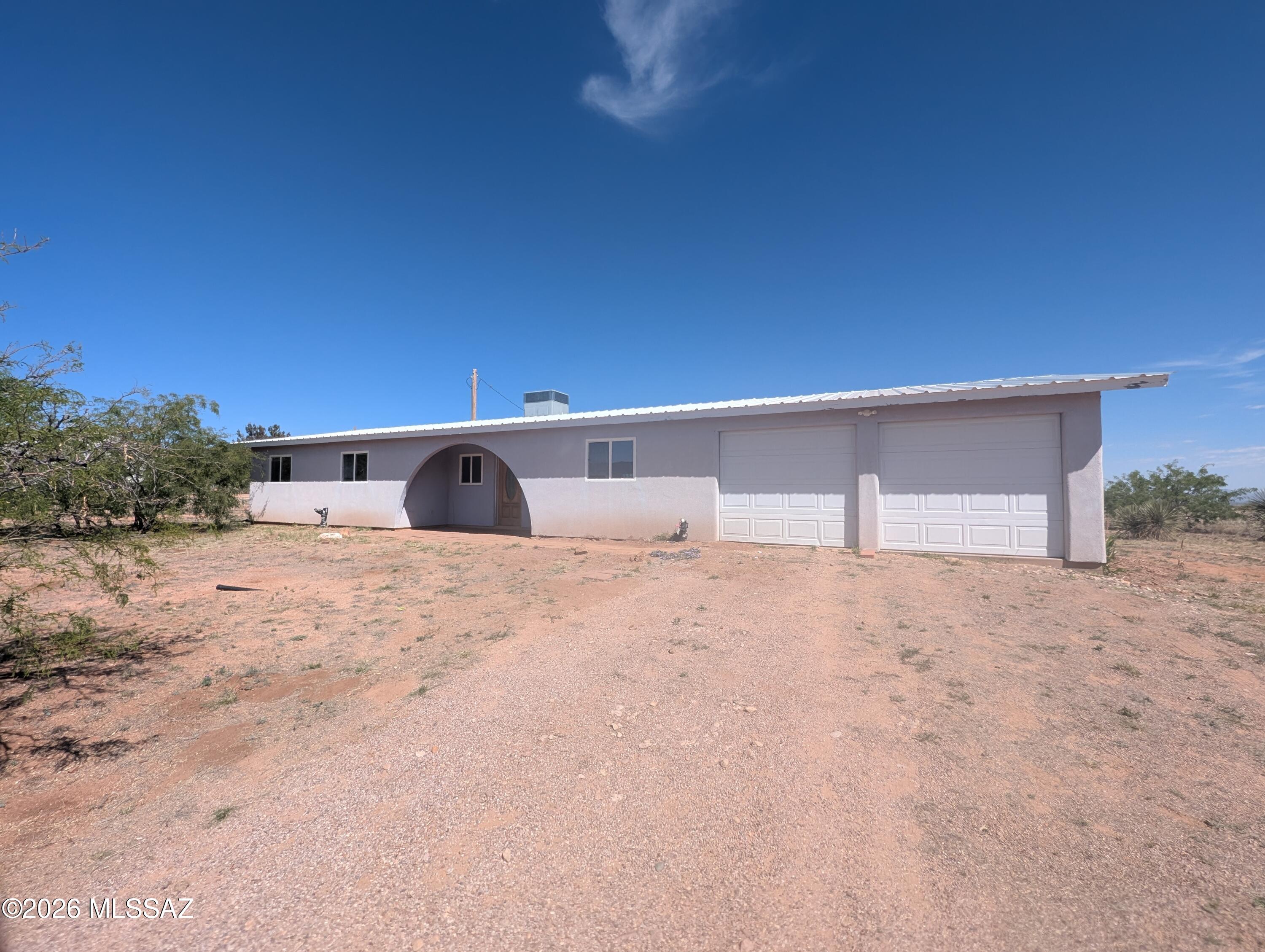 Spacious home on a large lot with beautiful desert and mountain views. Open living area and functional kitchen with ample cabinet space and breakfast bar. Bathrooms feature solid wood cabinetry. Includes laundry room and an oversized garage with room for storage or a workshop. Enjoy a covered patio, greenhouse, and plenty of space to make it your own!