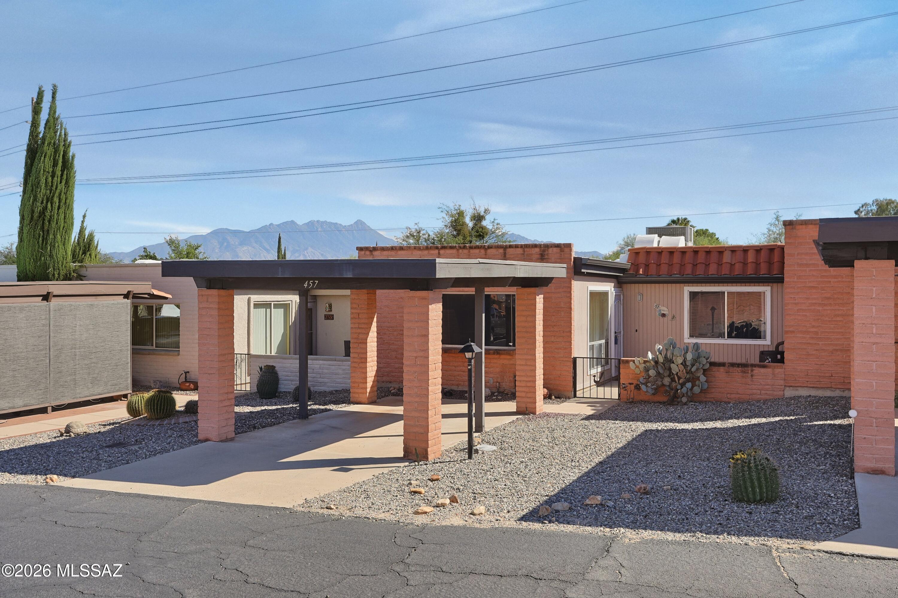 Quiet,  private location, this home backs to the lush green arroyo with mountain views.  Both bathrooms are updated with vanities and toilets.Brand new laminate flooring in Arizona room, lots of extra flooring and base board included. Skylights throughout, living room skylight has a plantation type shutter. Updated kitchen appliances, and a huge pantry. Pleasant rear patio with roll down screens. Az room is 15x11, and has a pet door.  Move in ready!