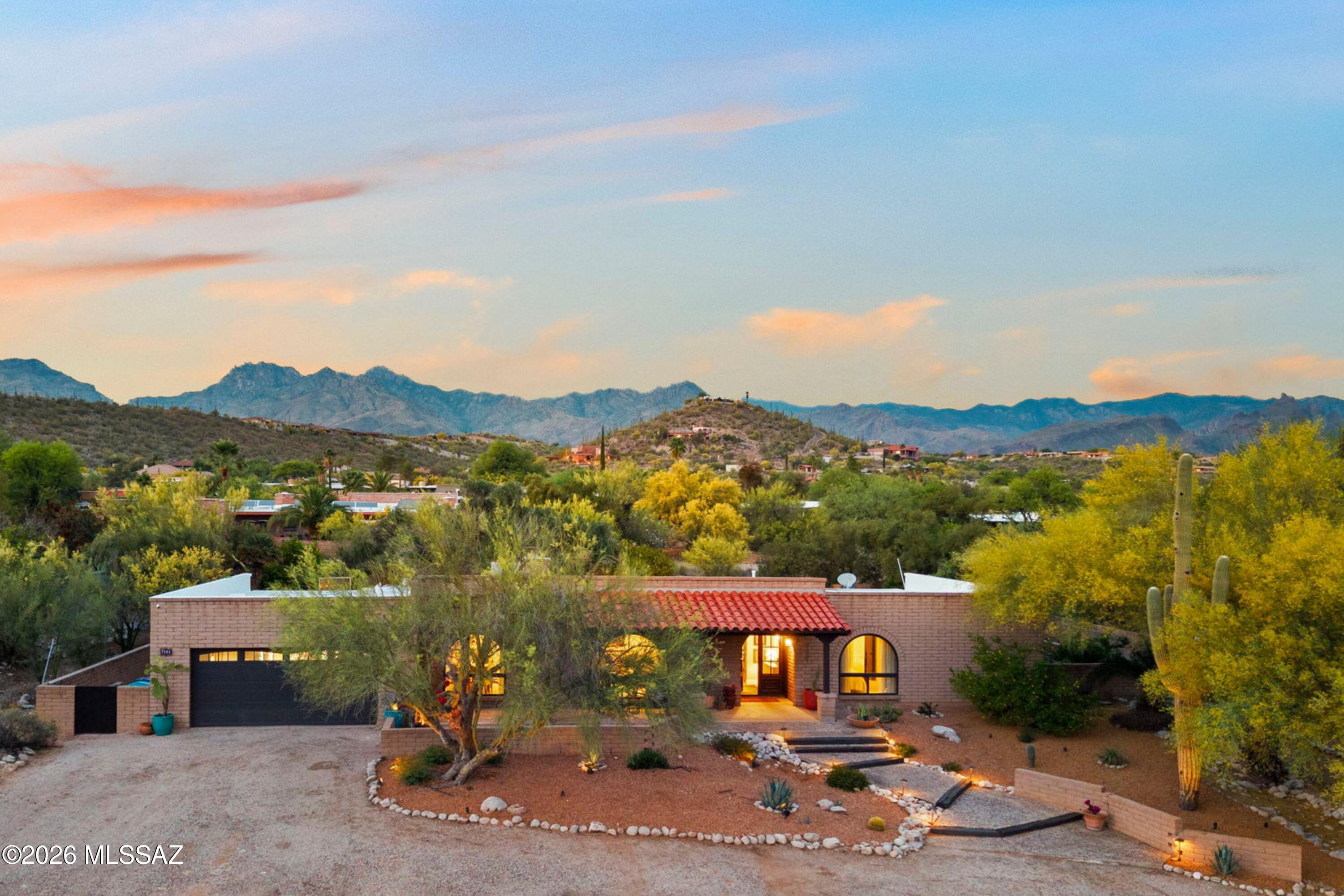 Tucked away in well-established Sabino Vista Knolls is your very own oasis! Remodeled 4 Bedroom & 3 bath slump brick home comes with beautiful iron front entry doors, beehive fireplace w/gas lighter, family room built-in bookcases, kitchen with nook & formal dining area.  The primary bedroom offers two closets and an ensuite bathroom that is thoughtfully designed with a dual vanity, mirrored closet, and a tiled walk-in shower with a floor safe in the closet. The backyard features a sparkling pool that compliments the fresh grass, flowering plants and lush trees providing shade. Enjoy mountain views from north-facing covered patio. Walk-in closets with spacious cabinets and drawers! Newly coated roof comes with 2-year warranty. New appliances; newly coated roof comes with warranty in addition to a Home Warranty. Fresh paint & new carpet! Owner/Agent