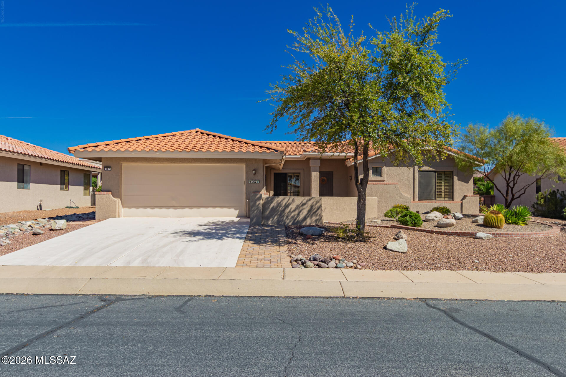 Welcome to active adult living at its finest in the vibrant community of Sun City Oro Valley. Showcasing stunning updates and beautiful mountain views, this bright and spacious home offers over 1,480 sq.ft. with 2 bedrooms, 2 bathrooms, plus a versatile hobby room/home office and a fully enclosed Arizona Room. Step inside to a generous great room and dining area with soaring vaulted ceilings, a custom stone-veneer accent wall, and stylish window shutters that create an inviting atmosphere. The updated tile plank flooring throughout adds to the modern feel. The beautifully updated kitchen features crisp white cabinetry, granite countertops, a custom tiled backsplash with decorative wall accent, sleek stainless steel appliances, and a charming breakfast nook.  The Arizona Room provides a comfortable year-round retreat that seamlessly blends indoor and outdoor living. The primary suite includes a lovely bay window, window shutters, and a private en suite bathroom, while the guest room offers flexibility with a Murphy bed, ideal for visitors or a home office. Outside, enjoy a serene patio with built-in seating and sweeping mountain views, perfect for relaxing or entertaining. This turnkey home is truly move-in ready, with all appliances, furnishings, artwork, and household items included!  Residents of Sun City Oro Valley enjoy access to exceptional amenities including golf, a pool, tennis and pickleball courts, a clubhouse, fitness facilities, and a wide variety of activities and clubs.  All located just minutes from shopping, dining, medical facilities and recreation areas.