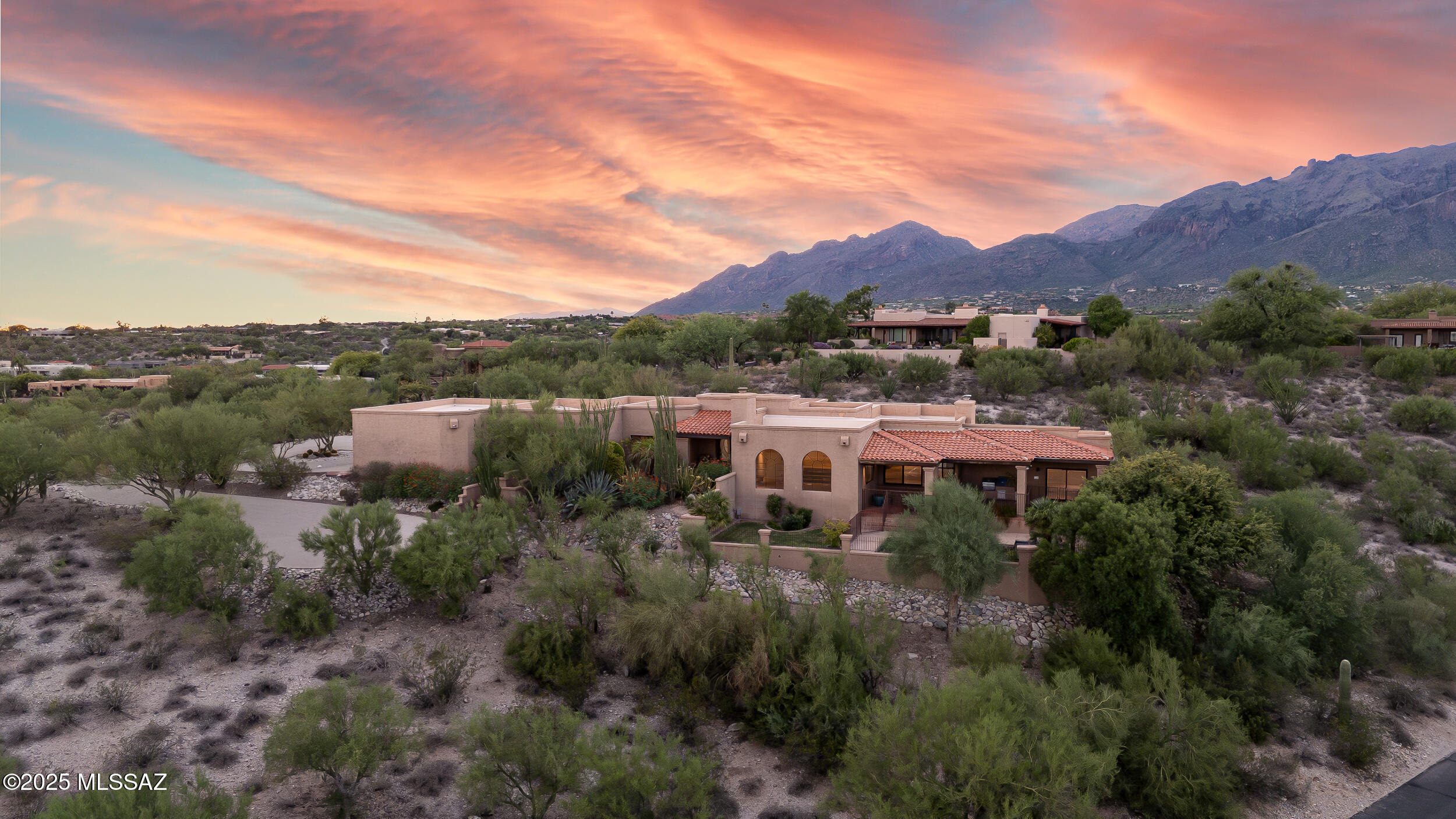 Welcome to 3841 E Placita Sumo in the prestigious Catalina Foothills Est No. 10! From the start, you will observe a beautiful serene natural desert setting & curb appeal w/ a custom aggregate concrete driveway & ample parking for all your guests. This sprawling hill top 1.7 acre lot provides privacy w/ dramatic views of the city & Catalina Mtns that can be seen from picturesque windows throughout. Bright & spacious floor plan w/ tons of versatility. Gourmet kitchen w/ Wolf cooktop/double ovens/warming drawer, Built-in coffee/espresso machine, SubZero Fridge. & hidden pantry. Separate livingroom/familyroom concept & dining area. 5th bedroom & flex room could be used as guest quarters w/ its own bathroom & separate entrance. Continued> Professional designer features throughout home created by the renowned, Lori Carroll, include kitchen, Familyroom, bathrooms, and more.

Custom entry doors created and design by glass artist, Melissa Paxton.

3  patios:
#1 - Main overlooking the pool & city lights. 
#2 - Off kitchen with orange and lemon citrus trees and mature vegetation
#3 - On north side of Familyroom with Catalina Mtn views

Just minutes from your doorstep at 3841 N Placita Sumo, discover a world of upscale dining, outdoor adventure, and cultural attractions. Enjoy fine shopping and gourmet restaurants at La Encantada, or catch live music and art festivals at DeGrazia Gallery in the Sun. Hike scenic desert trails at Finger Rock Trailhead and Sabino Canyon, both just a short drive away. Golf enthusiasts will appreciate the proximity to Ventana Canyon and La Paloma Resorts. With top-rated schools, serene city & mountain views, and easy access to central Tucson, this location offers the perfect blend of tranquility and convenience in the Catalina Foothills.