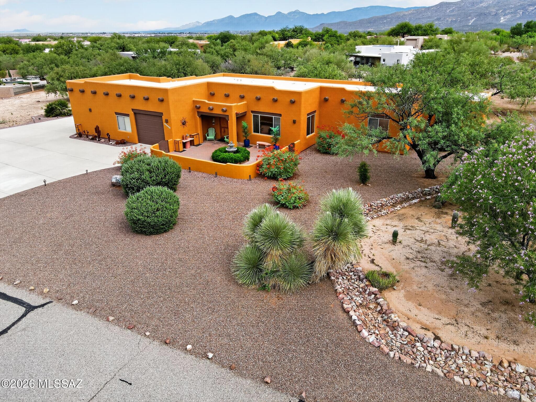 Beautiful original owner Santa Fe style home in highly desirable Antler Crest Estates on just under an acre in award winning Vail school district w/oversized 3 car garage & separate 23'x12' workshop w/electric, & skylights.Large staggered tile throughout except BR's.Kitchen is a cooks delight w/granite countertops.upgraded cabinetry,skylight & large walk in pantry. Large family room w/fireplace for those cool winter nights.Front courtyard w/fountain is a great hang out spot.For a larger group the back north facing patio is fantastic w/66' long covered patio area w/fans & lots of beautiful tile, built in BBQ, & oversized ramada providing lots shade. BR's are good size,Primary BR has patio access & jacuzzi tub w/separate shower.Newer HVAC(2016), water heater(2025).Exterior Painted(2026).