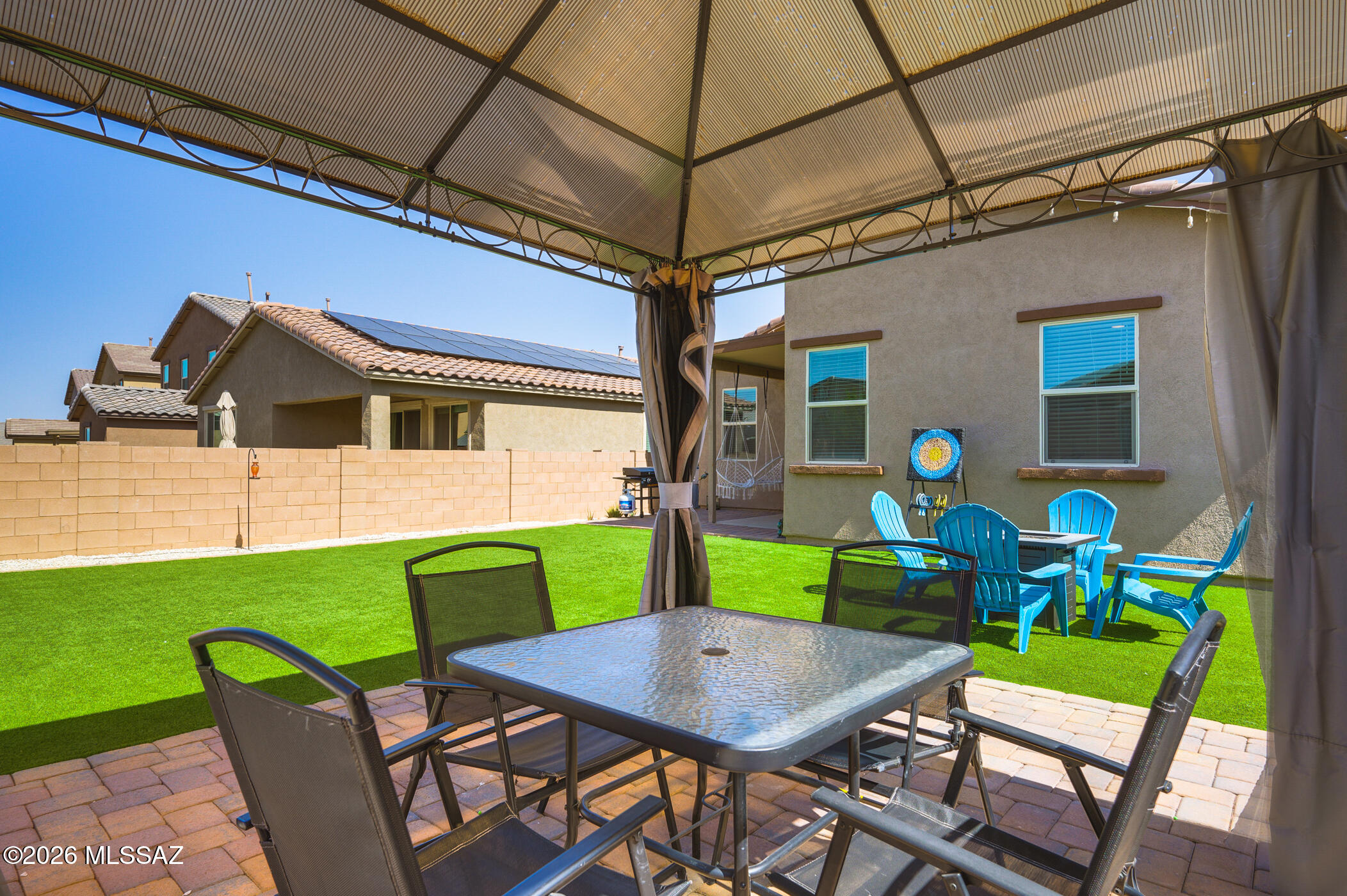Welcome to Entrada Del Pueblo in Rancho Sahuarita. Located in a newer community, this home sits just a short stroll from the Rancho Sahuarita Clubhouse and Sahuarita Lake, giving you easy access to recreational activities and community events right outside your door. Built in 2023, the home features a spacious open floor plan that creates an inviting and airy feel. The well-appointed kitchen includes sleek laminate countertops, stainless steel appliances, and ample cabinet space. From the kitchen sink, you can look out into the living room--perfect for keeping an eye on the kids, watching TV, or staying connected while entertaining. The main living areas showcase beautiful white tile flooring, while the bedrooms offer comfortable carpeting. The primary suite is generously sized, complete with a walk-in closet and a well-proportioned bathroom. Step outside to a professionally landscaped backyard featuring pavers, turf, and white gravel, creating a clean, low-maintenance outdoor space. The two-car garage includes additional storage and upgraded lighting. The nearby Rancho Sahuarita Club House features a fitness center, swimming pools, and a variety of social activities. The scenic lake offers opportunities for paddle boating, fishing, and has peaceful trails along its shores.