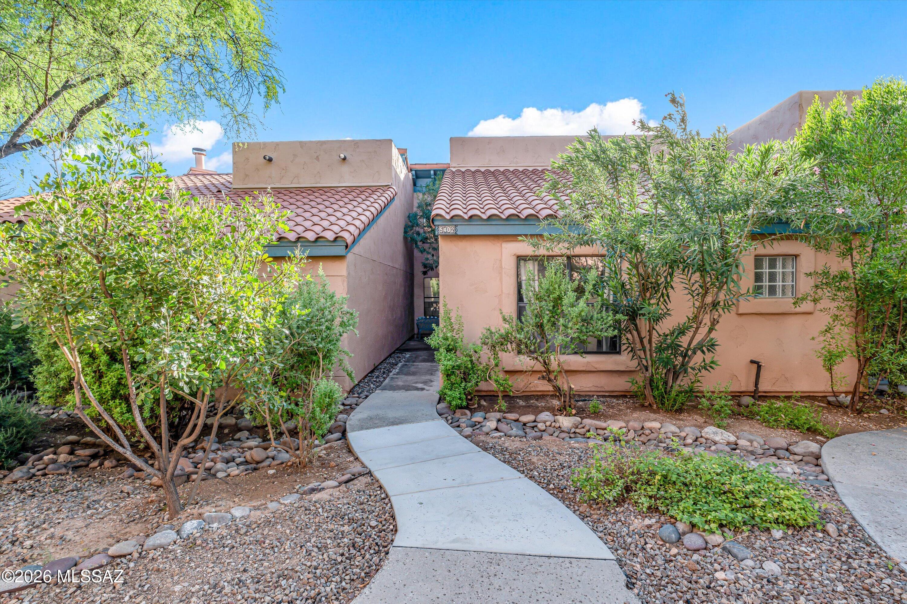 Catalina Foothills living with a resort-like feel.  This beautiful townhome offers a comfortable, low-key retreat in an exceptional location - just ¼ mile from Sabino Canyon and minutes from other popular outdoor activities, dining, shopping, and everyday conveniences.

The special features of this home include an open floor plan with a soaring ceiling in the great room, skylights, and a loft - all making it feel more spacious.  The loft offers additional living space with privacy, ideal for a home office, art studio or guest bedroom.  Unique touches include gorgeous blue retro-inspired tile work in the bathrooms and countertops in the kitchen, and a distinctive tile accent surrounding the fireplace and a spiral staircase leading to the loft.  

You will also love the serene desert li this community offers.  There are two heated pools (one is a lap pool), manicured common areas, walking paths, tennis court, fitness room, and a clubhouse.  All appliances convey. Roof replaced in 2026.  The HOA pays for roof and exterior maintenance, fire protection, street and carport maintenance, common area landscaping, and water/sewer/trash, and community amenities.  Furniture and houseware items can also be included at no cost.  Buyers must be represented by Realtors.  No site-unseen offers please.  Come see and make this special townhome your new home!