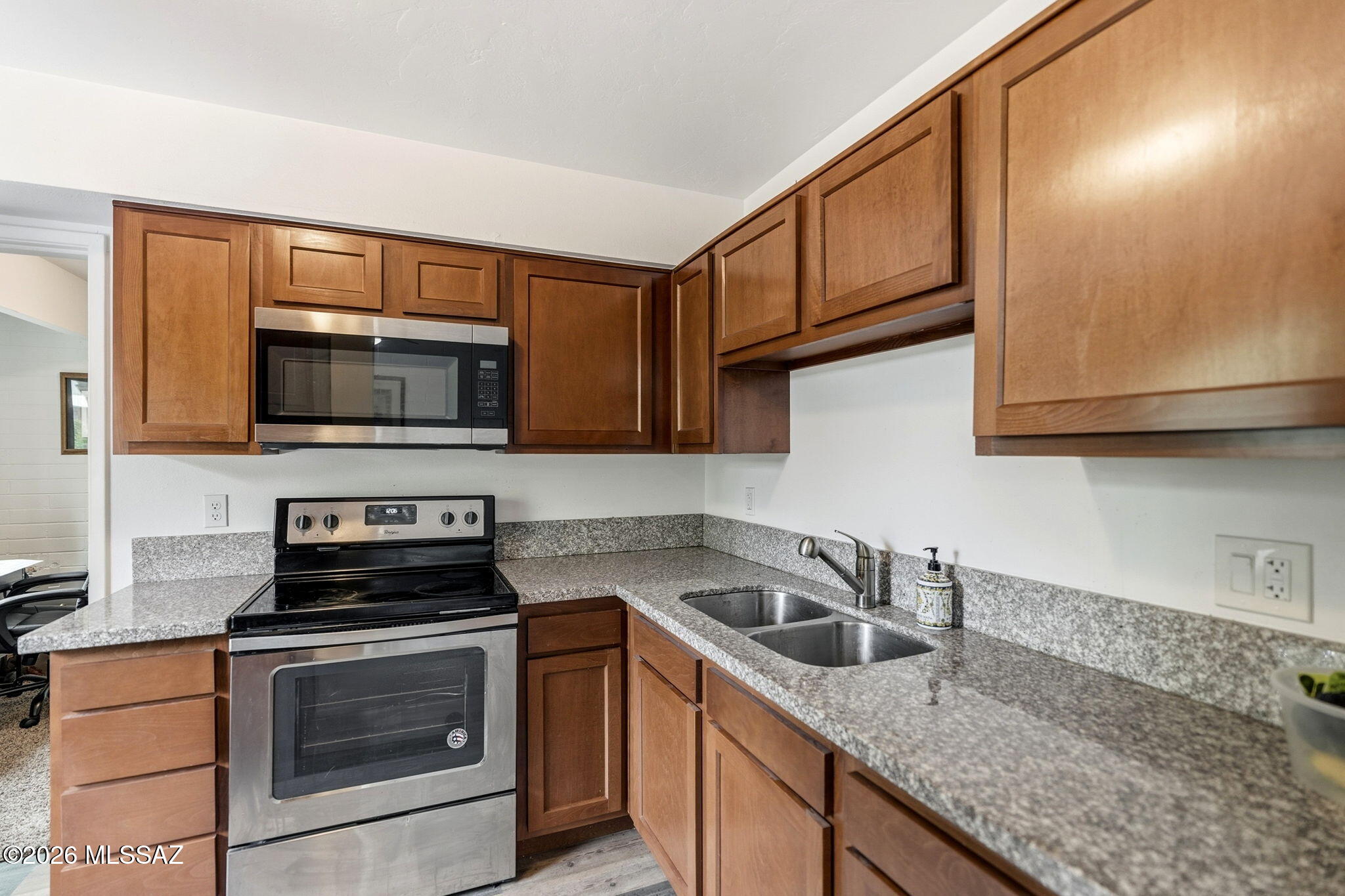 Bright and inviting 1 bed condo featuring granite countertops, stainless steel appliances, and fresh interior paint throughout.  The bathroom offers a stylish tile-to ceiling tub surround adding a modern touch.  Enjoy a pleasant view of the interior courtyard and stay comfortable year-round with a well-maintained AC unit.  The bedroom includes generous closet storage, making organization easy.  Enjoy community pool, hot tub, basketball court, clubhouse, laundry facilities, permitted parking, and well-kept common areas!  Close to public transportation and shopping, Cash ONLY!