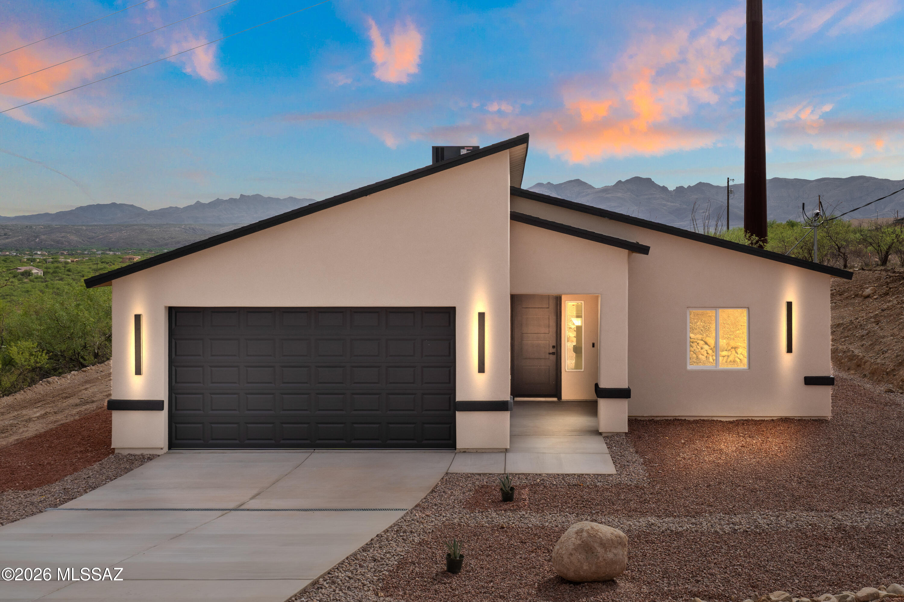 Perched on a scenic hillside, this 4-bedroom, 2-bathroom home offers 1,732 sq ft of modern living with breathtaking mountain and city views. The elevated lot provides privacy while showcasing sweeping vistas from multiple areas of the home.

Inside, clean lines and contemporary finishes define the space, including quartz countertops and large-format 24x48 ceramic tile flooring for a sleek, low-maintenance feel. The open layout seamlessly connects the kitchen and living areas, ideal for everyday living and entertaining.

Striking modern pitched rooflines with varied angles give the home a unique, elevated curb appeal. With its blend of style, function, and unbeatable views, this hillside property offers a rare opportunity for refined living.