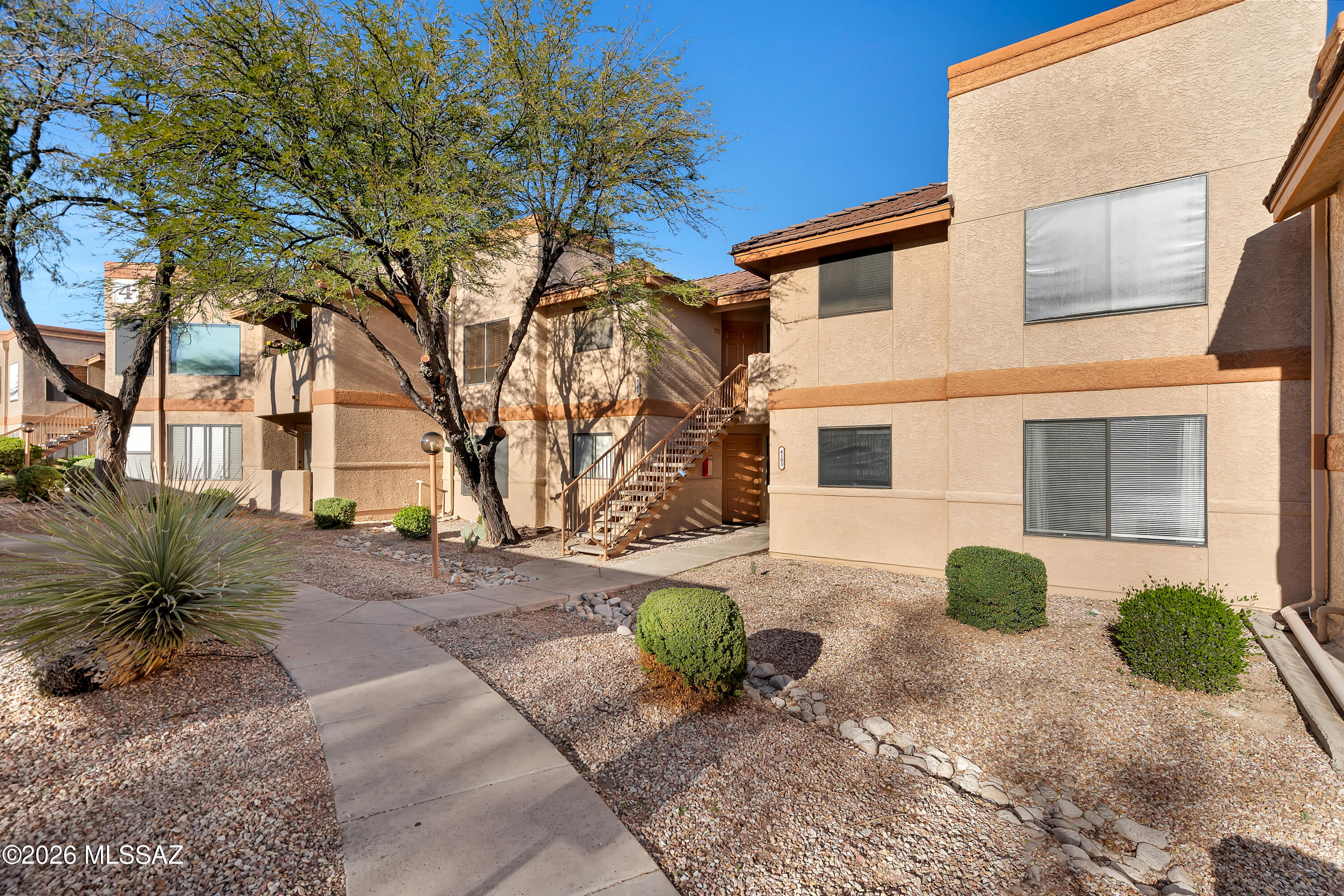 Beautiful quaint condo in the heart of the Foothills!  Meticulously maintained 2BR/2BA ground floor unit with backyard mountain views from a private patio.  This rare find boasts wood panel flooring, stainless steel appliances, quartz countertops, and neutral interior paint.  Perfectly situated in the award winning Catalina Foothills A+ school district, and just a few miles from the Sabino Canyon Recreation Area, Canyon Ranch Resort and Spa, world-class hiking/biking, fine dining/shopping, and golf.  Amenities include gated entry, upgraded heated Pebble-Tec pool and spa, workout facility, and covered parking.  Don't miss this unique opportunity to own a personal slice of paradise!