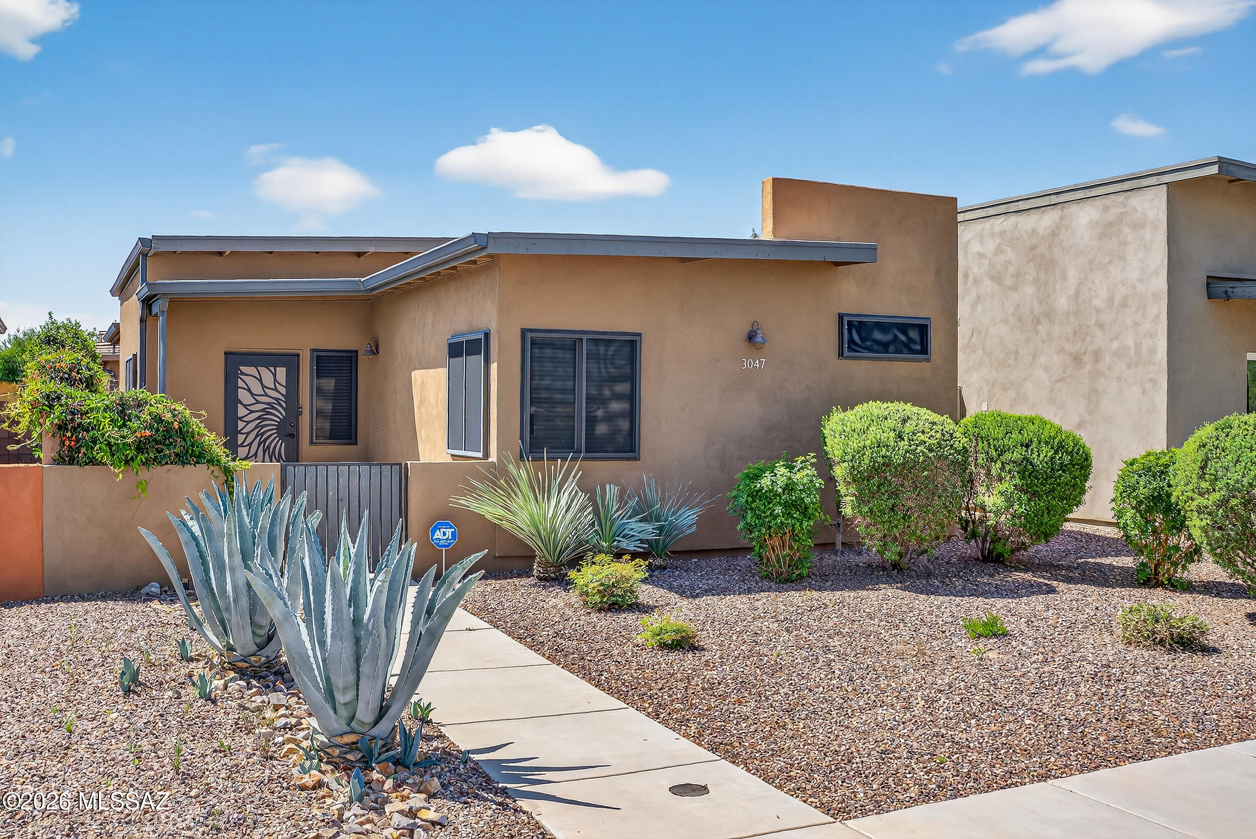 RANGE PRICING- Seller will accept offers between $335,000- $350,000 Welcome to 3047 N Dales Crossing, where modern design meets effortless Tucson living in one of the city's most convenient westside locations. Just minutes from downtown, major hospitals, dining, golf, and everyday essentials, this home offers the perfect balance of accessibility and privacy within a small, well-kept enclave.
Built in 2018, this thoughtfully designed Pepper Viner home showcases quality craftsmanship and intentional upgrades throughout. The open-concept layout is anchored by a stunning kitchen featuring quartz countertops, a large center island with breakfast bar seating, stainless steel appliances, gas range, and elegant pendant lighting. The seamless flow into the living and dining spaces, enhanced by rai and inviting atmosphere.
Luxury vinyl plank flooring runs throughout the home, offering both durability and style. The primary suite is privately positioned and designed for comfort, featuring a spacious layout, mountain views, and a beautiful custom-tiled walk-in shower. A well-sized guest bedroom and upgraded full bath provide flexibility for guests, a home office, or additional living needs.
The welcoming front courtyard offers additional outdoor living space facing east, perfect for enjoying Tucson's mountain views.
Additional features include a two-car garage, washer and dryer, and ample parking in the front.
Homes in this community rarely come available, and this one stands out for its condition, upgrades, and location. If you've been waiting for a move-in ready home that truly delivers on both style and function, this is it.