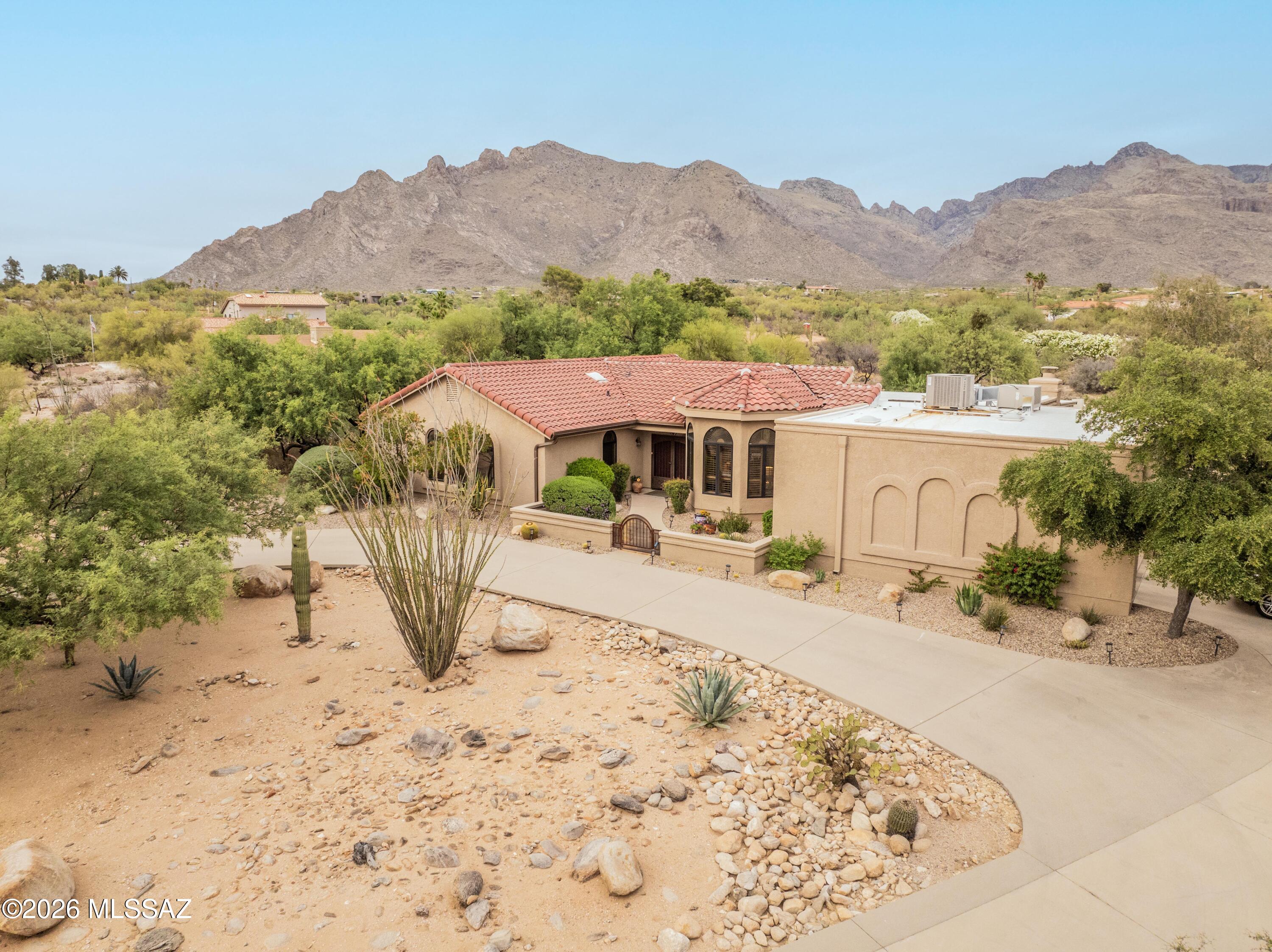 Great home with stunning mountain views in this beautiful Westward Look foothills neighborhood. Come see this refreshed Tucson home. The kitchen?s been updated, tile runs throughout, and Pella windows bring in tons of light and those killer views. Cozy wood-beam sitting room adds charm and a great spot to unwind. Living has a beehive fireplace to enjoy on those chilly desert nights. 
Outside is pure backyard bliss ? a pool, gorgeous landscaping, and plenty of space to hang out or entertain. Comfortable, easy living with a view you'll love.  This home is a must see with NO HOA! Close to shopping schools and everything you need.