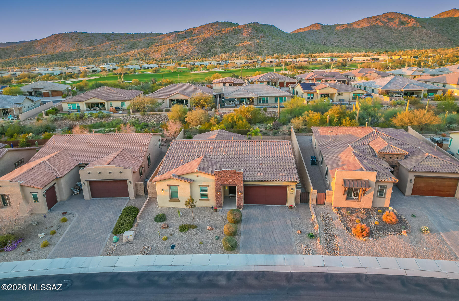 Located within the prestigious, gated Boulder Pass community in Dove Mountain, this beautifully upgraded 3BD/2BA, 2180 sq ft home plus den offers refined desert living with breathtaking mountain views. Step inside to an inviting open-concept floor plan where a spacious great room flows seamlessly into the chef's kitchen and dining area perfect for entertaining. The kitchen showcases highly upgraded cabinetry, premium countertops, and upgraded appliances, combining style and functionality. The expansive owner's suite serves as a private retreat, featuring a luxurious ensuite with dual vanities, a soaking tub, walk-in shower, and generous walk-in closet. A desirable split floor plan provides privacy, with two additional bedrooms and a full bath thoughtfully positioned on the opposite side of of the home. The versatile den, enhanced with custom barn door, is ideal for a home office, gym, or flex space. Additional custom touches include a well-appointed laundry room with built-ins and a farmhouse sink, plus a fantastic mudroom with more custom built-ins perfect for everyday organization. Step outside to your private backyard oasis. The extended travertine patio overlooks professionally landscaped grounds with turf, a gas fire pit, and those unbelievable mountain views and spectacular Arizona sunsets. Additional highlights include epoxy-coated garage floors and meticulous maintenance throughout the interior and exterior. The home is ideally situated near premier golf courses, scenic walking paths, hiking and biking trails, and is within walking distance to the luxurious The Ritz-Carlton, Dove Mountain spa and resort offering world-class amenities just moments from your doorstep.