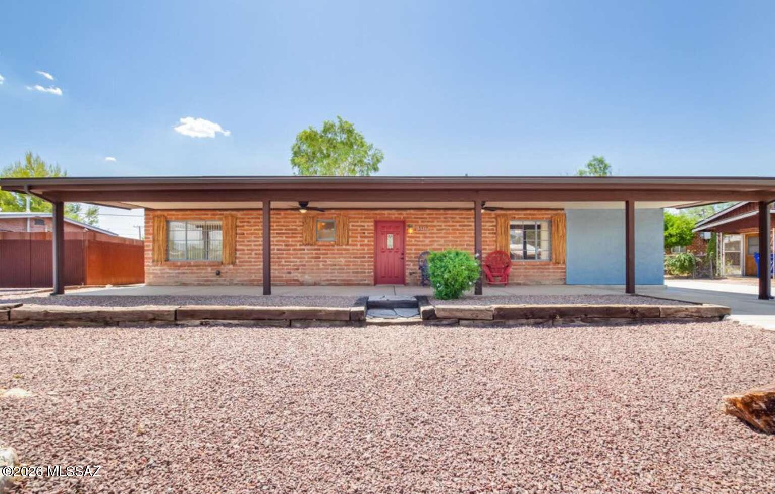 This charming 3-bed, 2-bath + extra room for potential 4th br property in turn-key condition is the one for you! This house offers plenty of parking space & a welcoming front porch. Saltillo tile flooring, painted sinks, ceiling fans, & a large living room are features you'll find inside. The beehive fireplace & French doors to the back patio complement the living room. Lovely eat-in kitchen...