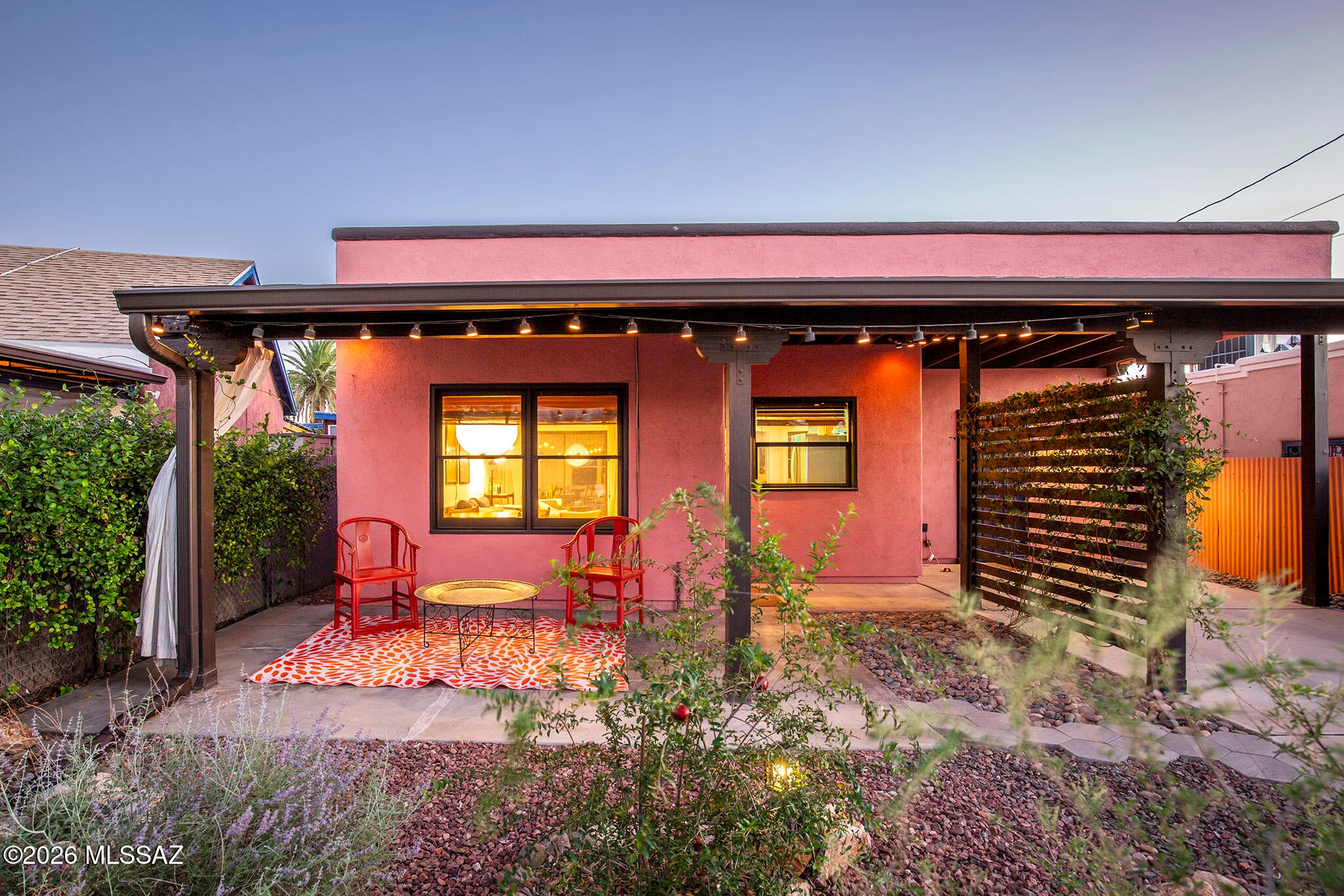 Tucked into historic Barrio Viejo in the Elysian Grove subdivision, this inviting 1992 built home sits along the narrow streets and intimate blocks that give this pocket of the neighborhood a character all its own, at times feeling more like a small village than the heart of Tucson.
The home offers a simple, comfortable floor plan with a Southwestern contemporary design influenced by Tucson's traditional Territorial architecture. Stucco walls, a flat roofline, deep covered porches, and an easy connection between indoor and outdoor spaces give the home a distinctly Tucson feel. Inside are high ceilings, exposed ductwork, an updated open kitchen, and a renovated bathroom.
Outside, the front and back porches create welcoming places to sit and gather, while the thoughtfully xeriscaped yard is filled with native and desert adapted plants and trees. Water harvesting tanks help support the landscape and raised bed vegetable gardens. Owned solar adds everyday efficiency, and a covered carport provides convenient off street parking.
Walk to Coronet Café, EXO Coffee, neighborhood gathering spots, and the restaurants, arts, and entertainment of downtown Tucson.