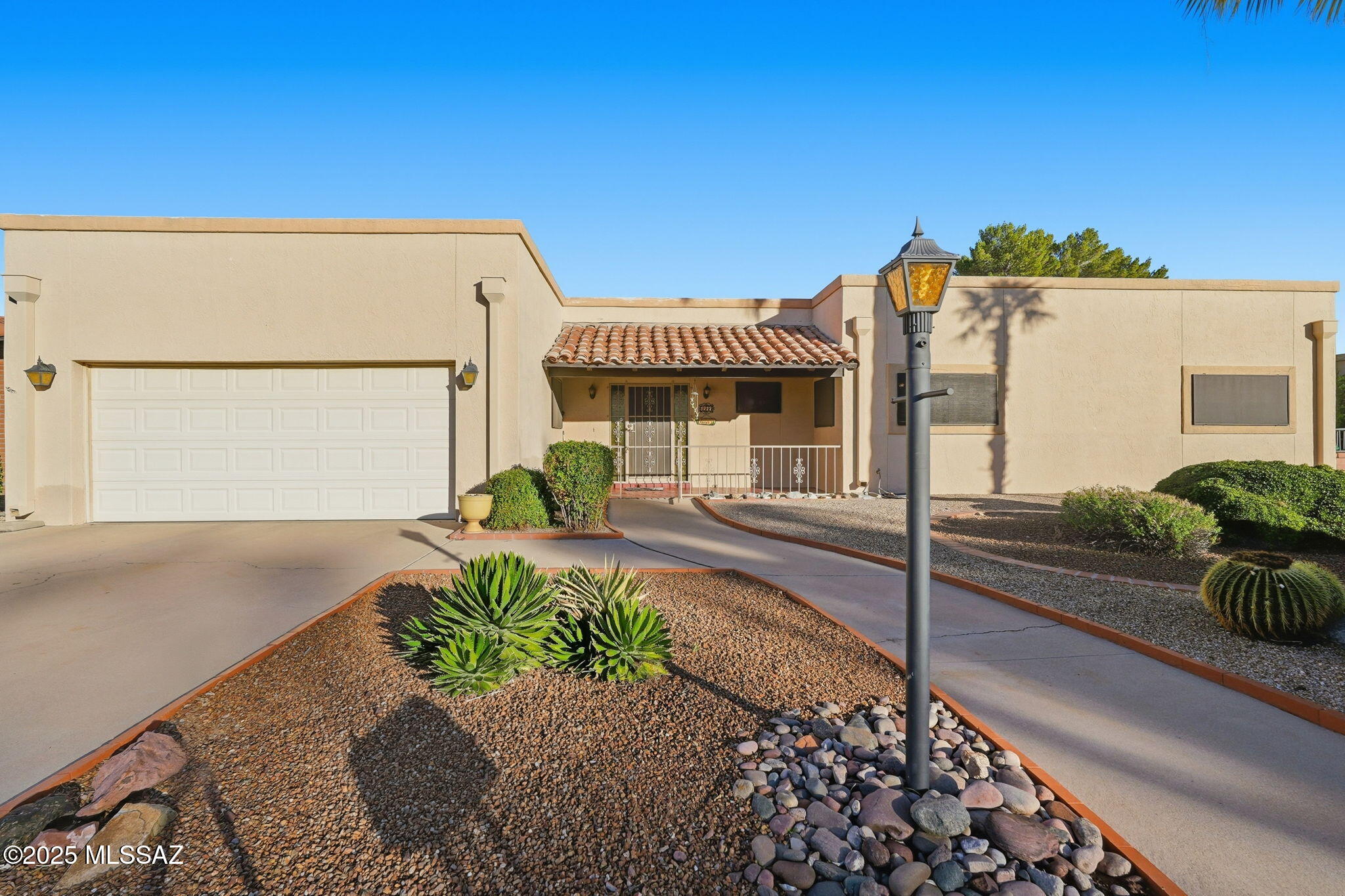 Now with 2 brand new HVACS, as of 2/10/26! Welcome to Country Club Estates, right on the golf course but positioned in a way that protects from errant shots and provides a private feel in the backyard, with wrap-around pavers and flagstone plus a rock pond/waterfall. AZ room was updated with windows and cooled by a mini-split. Breakfast nook next to kitchen was added on, providing more space and another exit to the backyard. Silestone kitchen counters, beamed ceilings in living room and Saltillo tile give this home a true southwestern charm. Two car garage has extended space with storage. Roof was re-coated this year. Front porch has a fence in which you can enjoy beautiful Green Valley twilight times. This home has been meticulously cared for and is a true winner. See for yourself today.