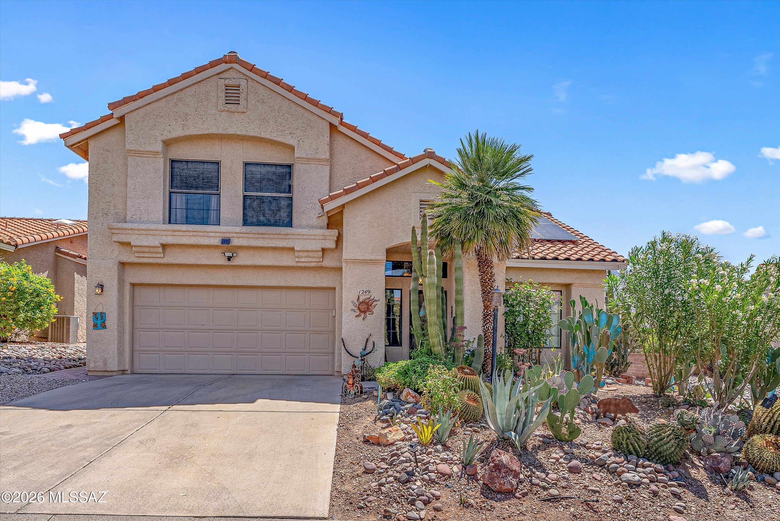Desirable golf course lot located in a gated community, all in the heart of Oro Valley.  Beautiful mountain views, gourmet kitchen, granite countertops, breakfast bar, custom cabinetry, bay window, den with a fireplace, slate tile throughout the ground floor, wood laminate throughout the second floor, huge master suite with a private balcony, large walk-in closet, soaking tub, separate shower, and granite countertops.  The private backyard is designed to entertain, with a covered patio, built-in grilling station, pebble-tec pool, above-ground spa, fully landscaped, and views of Pusch Ridge. The solar system is owned and saves thousands on electricity.  This was a very successful AIRBNB and could be sold turn-key. Solar paid in full.