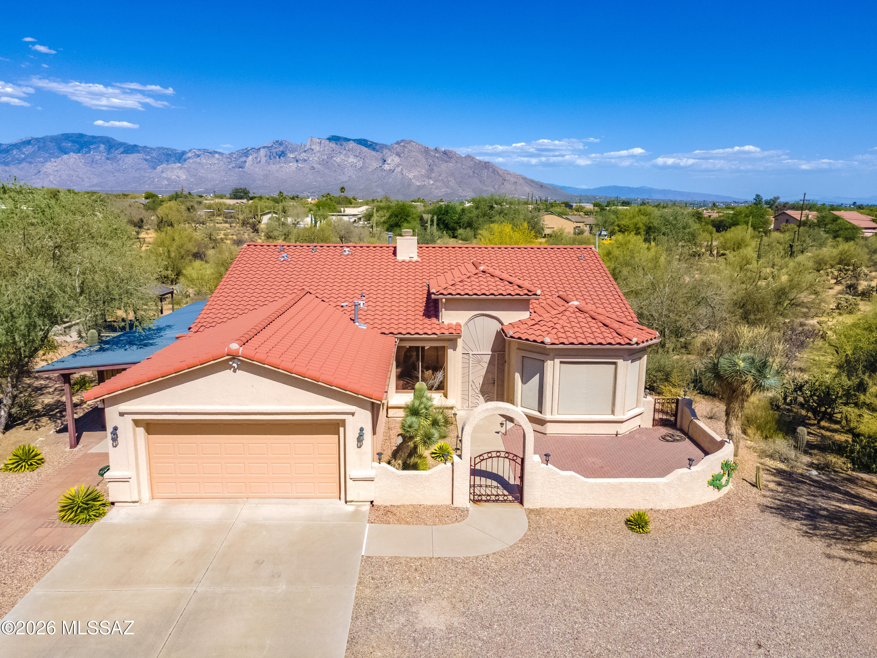 Bring Your Horses, Cars, & Big Dreams! Nestled on 3.37 acres zoned for horses, this distinctive property offers a 2,106 sq. ft. home with the rare combination of comfortable desert living & exceptional hobby space. The thoughtfully designed 2-bedroom plus den, 2-bath residence features high ceilings, custom finishes, ceramic tile throughout, a beehive fireplace, & a beautifully appointed kitchen w/custom cabinetry, granite counters, island, & GE appliances. The spacious owner's suite includes walk-in closet, dual vanities, oversized shower, & bay window w/electric rolling shutter. (More) Outside, the possibilities are endless. Car enthusiasts, collectors, & hobbyists will appreciate the attached garage plus a separate 1,000 sq. ft. insulated & air-conditioned garage as well as another 1,000 sq. ft. garage/workshop with its own bathroom & 220 service--creating space for up to 10 total vehicles, projects, RV storage, or potential guest-house conversion. Horse owners will love the expansive acreage, water access throughout the property, & room to create the equestrian setup that fits their lifestyle. Additional features include a welcoming courtyard entry, covered patio, decorative bridges and turtle enclosures, catio, & numerous energy-efficient construction upgrades. No HOA! A unique property offering space, flexibility, & freedom rarely found in today's market.