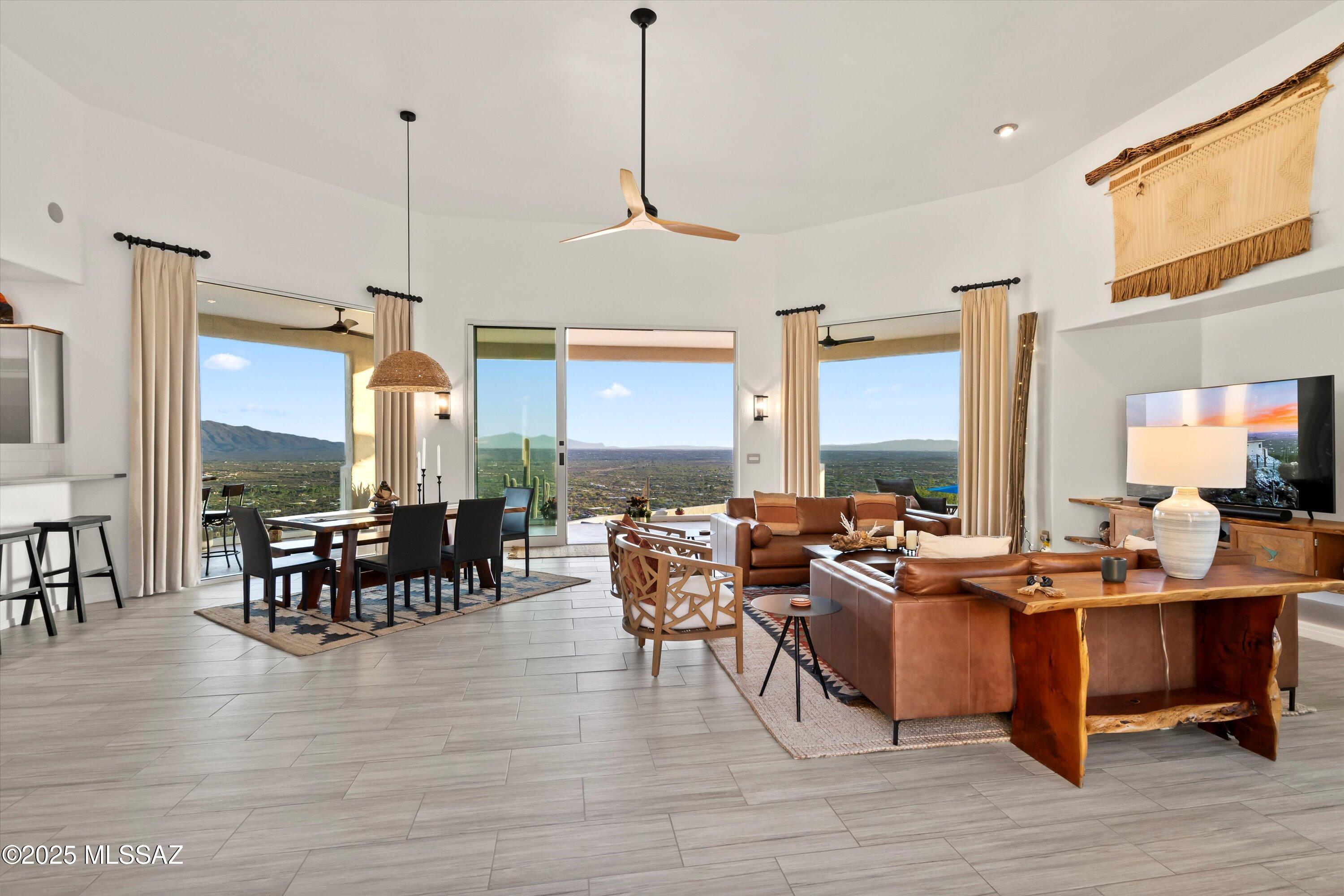 Panoramic mountain and city-light views in Milagrosa Hills. This private and elegantly furnished 3-bedroom, 3.5-bath retreat offers a harmonious blend of luxury, nature, and serenity. With 2,784 sq ft of living space, this home invites you to unwind and reconnect with nature. Walls of glass frame panoramic views of Tucson's twinkling city lights and the majestic Catalina Mountains. Proximity to Mt. Lemmon, outdoor lovers will appreciate easy access to scenic hikes, biking, and year-round adventure. The resort-style backyard—featuring a heated pool, spa, outdoor kitchen, and multiple lounge areas—is perfect for peaceful mornings or starlit gatherings. This is not just a home—it's a soulful desert escape, where nature and refined living meet. Owned solar system. List of ugrades availab Enjoy peace of mind with an owned solar system, a nearly new HVAC system, rolling exterior shutters, and central vacuum. The 3-car garage provides ample space for vehicles and storage, while every detail inside the home from its curated furnishings to the timeless finishes. This is more than a home it's a lifestyle.