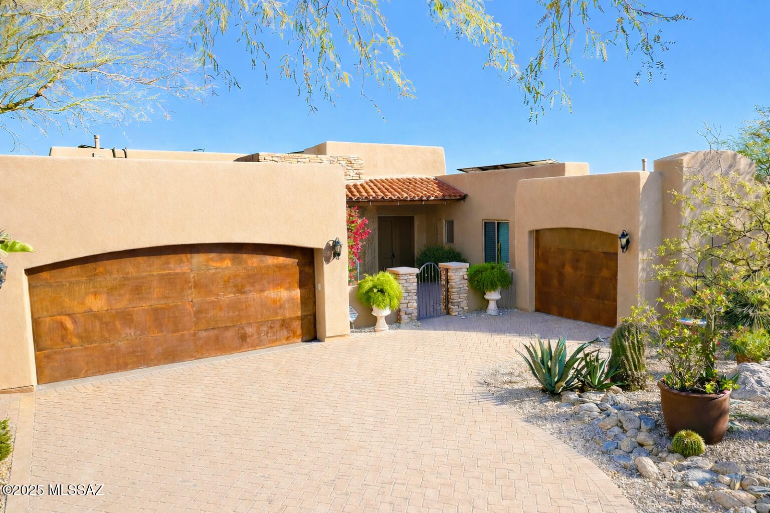 This home checks all the boxes you could ask for in luxury living in Tucson, AZ. Gated community with Custom Construction. Over 1.2 acres with over 3500 sq ft w/ high end upgrades. Unobstructed views of the Catalinas, gorgeous pool, hot tub, custom outdoor kitchen, and covered patios. Auto shades on Living, Dining and Primary Bedroom. Travertine and hardwood flooring throughout. No carpet/no steps! One level split floorplan with 3 Bedrooms w/ensuites. Den/Library/Office adjacent to additional 1/2 bath.  12 foot ceilings and Open Concept into Great Room. Upgraded stone fireplace, formal dining, breakfast area, and oversized kitchen with Custom Cabinetry and Built-in Refrigerator. East exposure to Primary, Great Room, Kitchen. Tesla Power Batteries to support Solar. Two new HVACs! Exterior Roll Shades. Surround Sound System inside and outside. Serene living in the middle of restaurants, shopping, and all amenities. No expense has been spared upgrading this home!