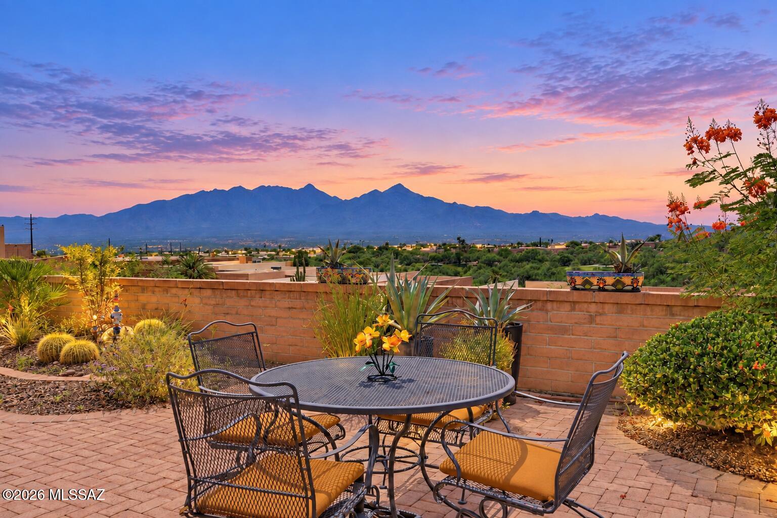Mesmerizing Santa Rita Mountain views take center stage from the private back patio of this beautifully appointed townhome, tucked away on a quiet cul-de-sac with no rear neighbor. Distinctive polished brick-paver flooring flows throughout, adding warmth and timeless Southwest character. The kitchen features granite countertops, rich alder wood cabinetry, stainless steel appliances and a gas range. The primary suite offers direct patio access through a sliding glass door, plus an accessible roll-in shower. Grab bars in both bathrooms add convenience and peace of mind. A 2022 roof provides an important update. Relax, entertain and enjoy breathtaking desert scenery from this special Green Valley retreat!