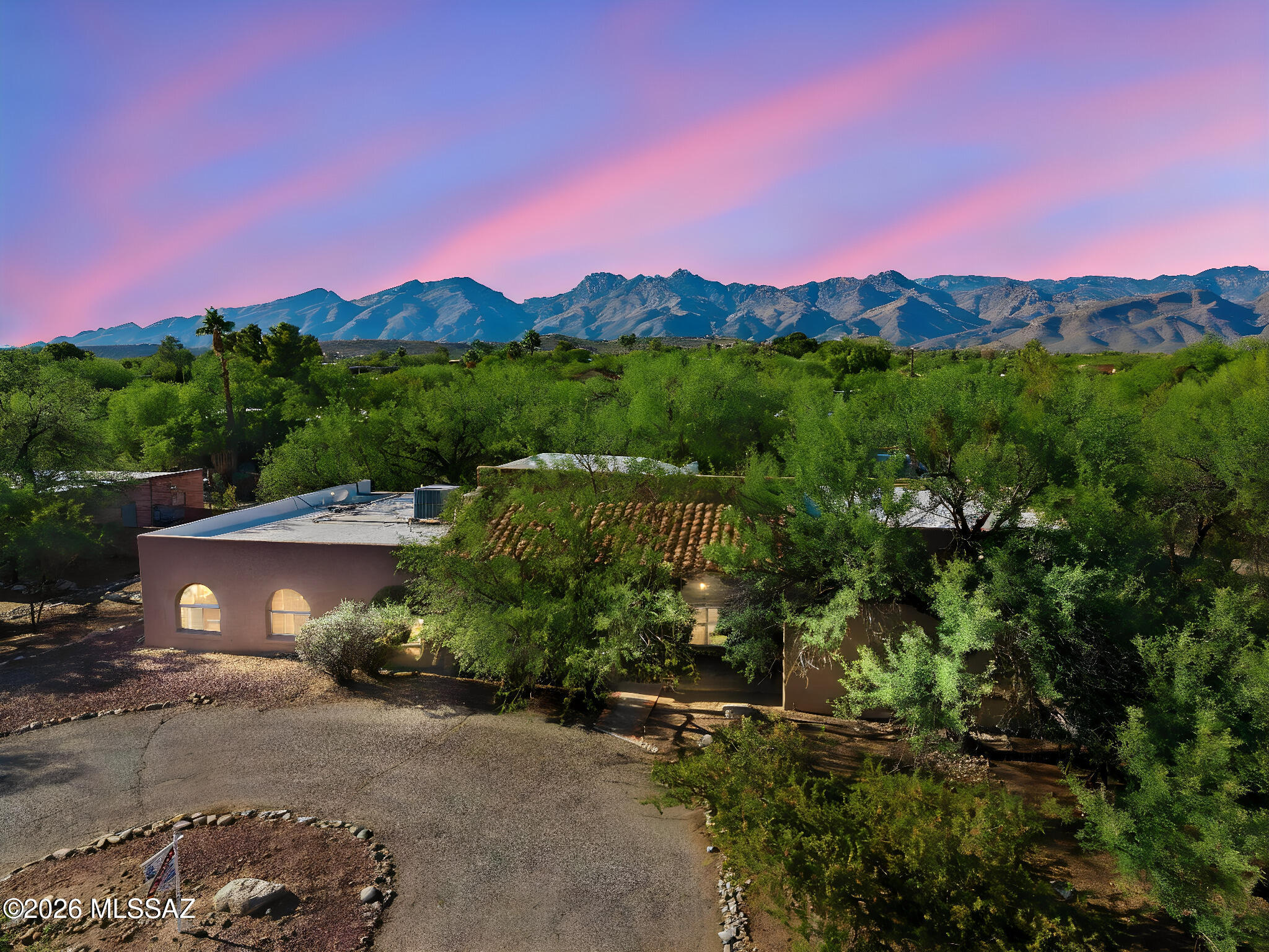 Pristine 3,400 sq ft custom home tucked away on a corner lot in a mesquite bosque.  Features include a suspended teak staircase leading to a loft style library, office or 5th sleeping area and a separate wet bar/game room. 
Additionally, the home features a chefs kitchen with upgraded features, newer appliances and solid cherry wood cabinetry.  The split layout features 3 separate sleeping areas.  A large primary suite with sitting area, fireplace and patio doors that take you out to a patio and spa/pool area.
A second primary bedroom, full bath, private patio doors to the pool is ideal for guests or multigenerational living.  2 other bedrooms share a full bath.  Outdoor amenities include a heated pebble tech pool and spa.  Trail head on the street