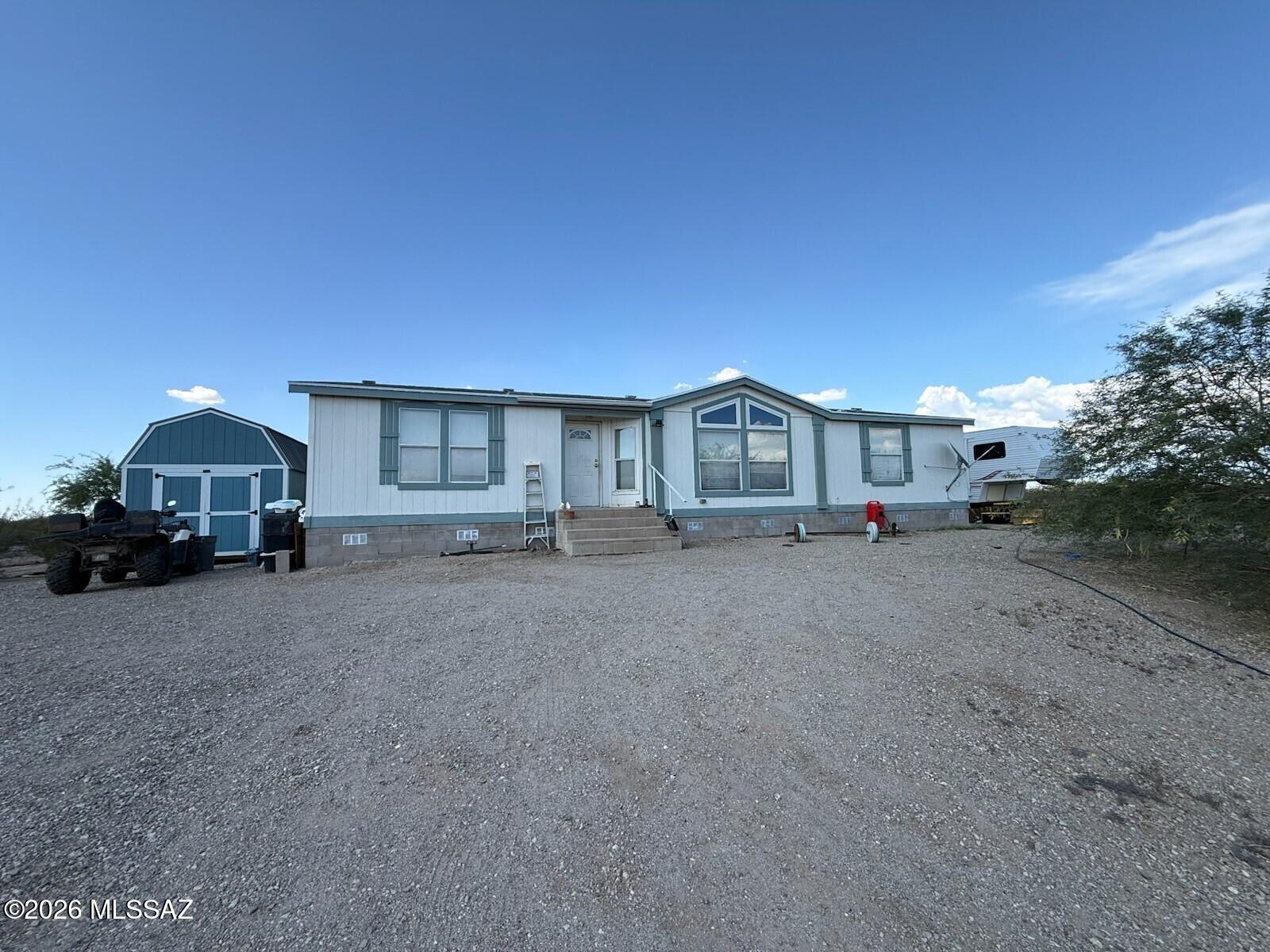 This is a Cavco manufactured home sitting high on a hill with 360 views, with the home totally fenced in. Home is ground set and looks down on the 6.77 acre property. Home has 3 bedrooms, 2 baths, a living room and a dining room off the kitchen. Master bath has a garden tub and separate shower. Included in the purchase are a 40 ft. Conex Box and a 16x20 lofted barn shed with a back door and two side windows. The 1997 27 ft. Jayco Eagle 5th Wheel (with additional septic and electrical for RV pad) is available on a separate bill of sale.