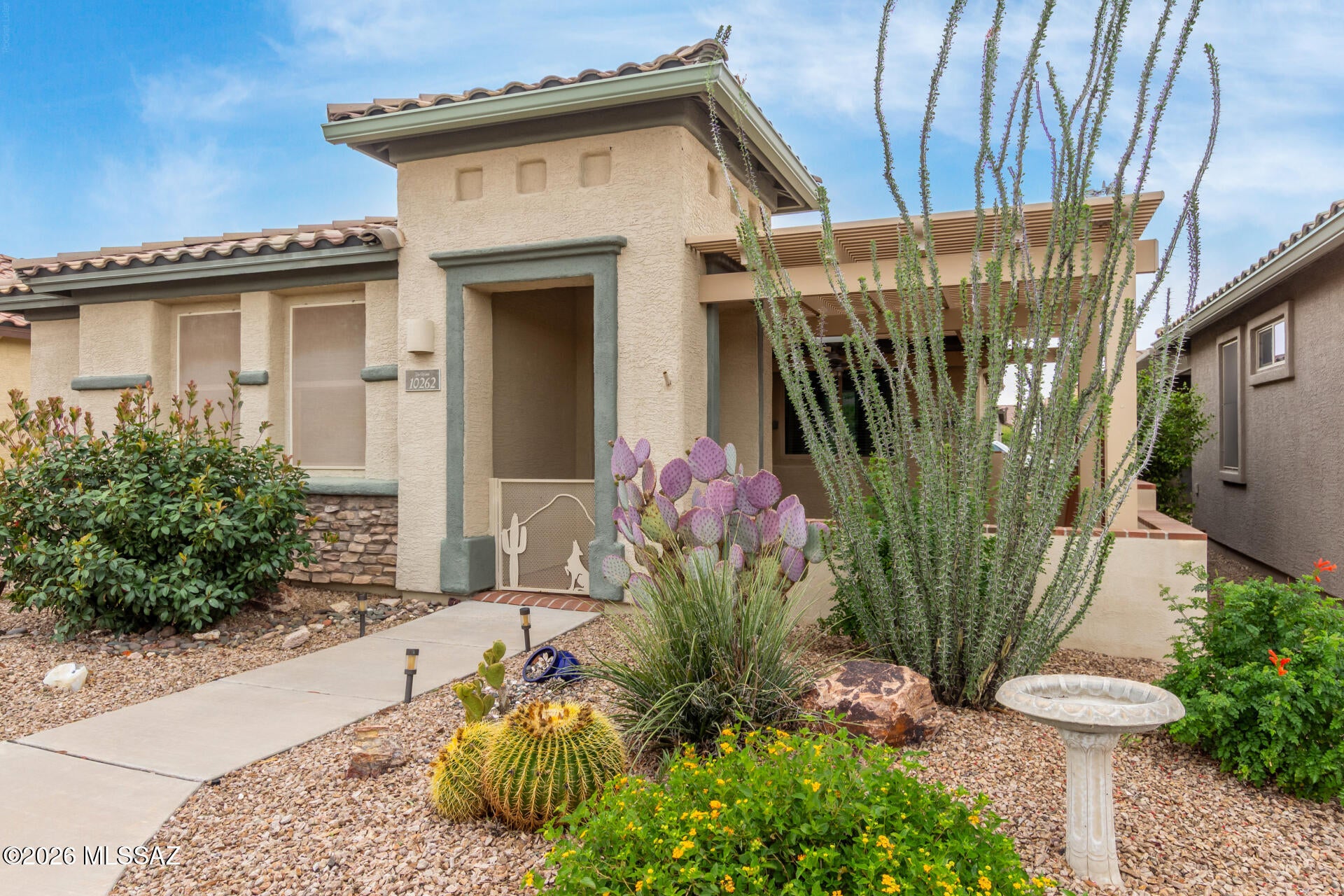 Beautifully cared-for 2 bedroom PLUS den/office, 2 bath Del Webb 55+ home with owned solar and a front patio facing the Rincon Mountains and open desert space--ideal for relaxing or entertaining. Tile flooring throughout and fresh interior paint. Kitchen features granite counters, 42'' upper cabinets, stainless appliances, gas range with double ovens, under-cabinet lighting, and pantry. The primary bedroom offers en suite bath and custom walk-in closet. Guest room includes a Murphy bed with fold-down table for flexible use. Tankless water heater and owned solar.  Garage has epoxy floor, 220V outlet, racks, cabinets, and second fridge. Washer, dryer, fridge, plus and two TVs convey.