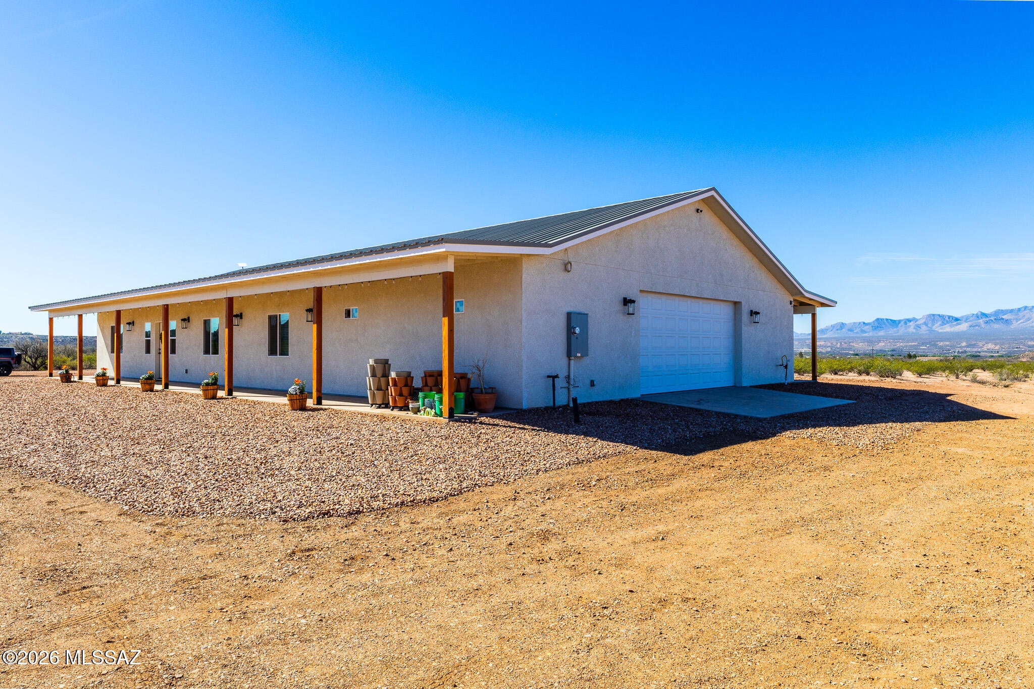 Enjoy modern country living on 10 acres with panoramic views and exceptional privacy. Built in 2024, this 4BR + large bonus room, 2BA home offers 2,464 sqft with an open floor plan, abundant natural light, and a desirable split-bedroom layout. The beautiful kitchen features solid alder cabinetry, granite countertops, a farmhouse sink, and a large walk-in pantry. The spacious primary suite includes an oversized vanity and custom-tiled walk-in shower. Expansive covered porches extend the living space outdoors. An oversized 989sqft garage, private well, shop-ready infrastructure, RU-4 zoning, large chicken coop, and plenty of room for RVs, animals, hobbies. This property is truly versatile. 10 +/- minutes from I-10 privacy, space, views, and modern comfort.