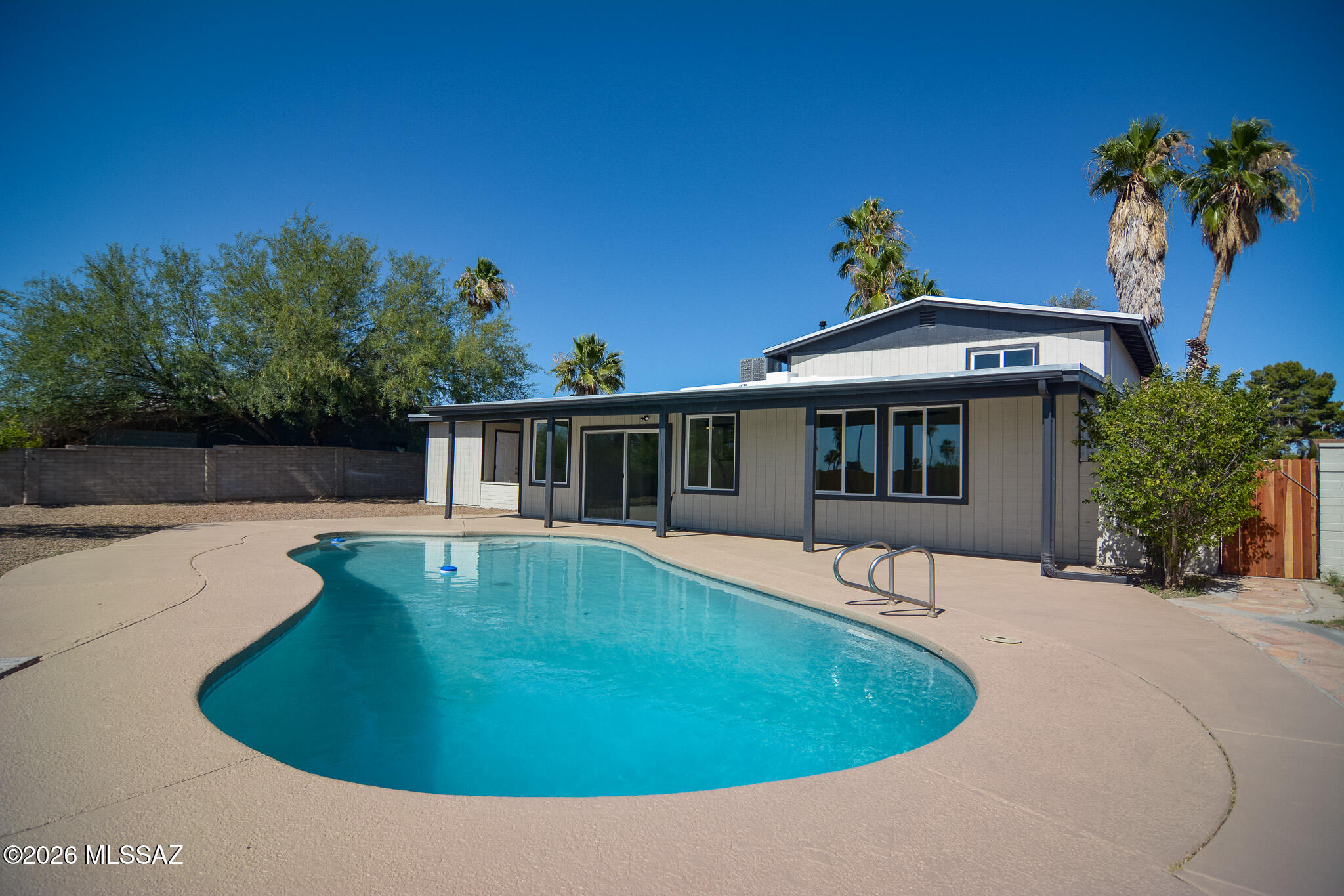 Beautifully remodeled contemporary style home. Located in a convenient Northwest Tucson location. Charming architecture. Rich wood look LVP flooring. Updated modern kitchen with stainless steel appliances. New custom interior and exterior paint. Updated remodeled bathrooms. Ceiling fans in each room. Large fenced yard. Sparkling pool. Storage shed. Mature trees. Oversized carport. Upgraded door hardware and light fixtures. New dual pane windows. New roof, HVAC, and water heater. No HOA. This home shows beautifully.