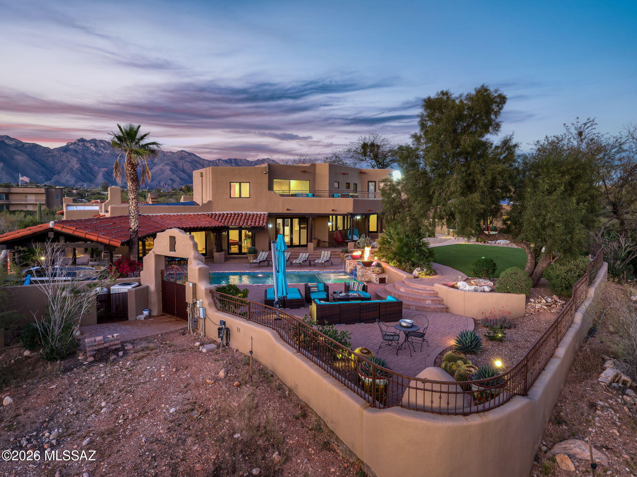 Own the ultimate private Tucson sanctuary -- Set on 3 acres with NO HOA, this 6,048 sq ft estate offers rare privacy, sweeping mountain views, and sparkling city lights. The resort-style backyard is unforgettable, featuring a dramatic stepped-tile fire-waterfall pool where flames rise above cascading water. Inside, soaring wood ceilings, six fireplaces, and expansive living spaces create warmth and grandeur. The chef's kitchen includes a Viking 6-burner range, Sub-Zero refrigeration, and dual ovens. The main-level owner's suite opens to a wraparound deck with breathtaking sunset views. Outdoors, enjoy a full kitchen, massive ramada, lush lawn, 4-car garage/workshop, and flex studio ideal for a gym, office, or creative space. Luxury, privacy, and freedom- Property website: https://placitacasario.com/
