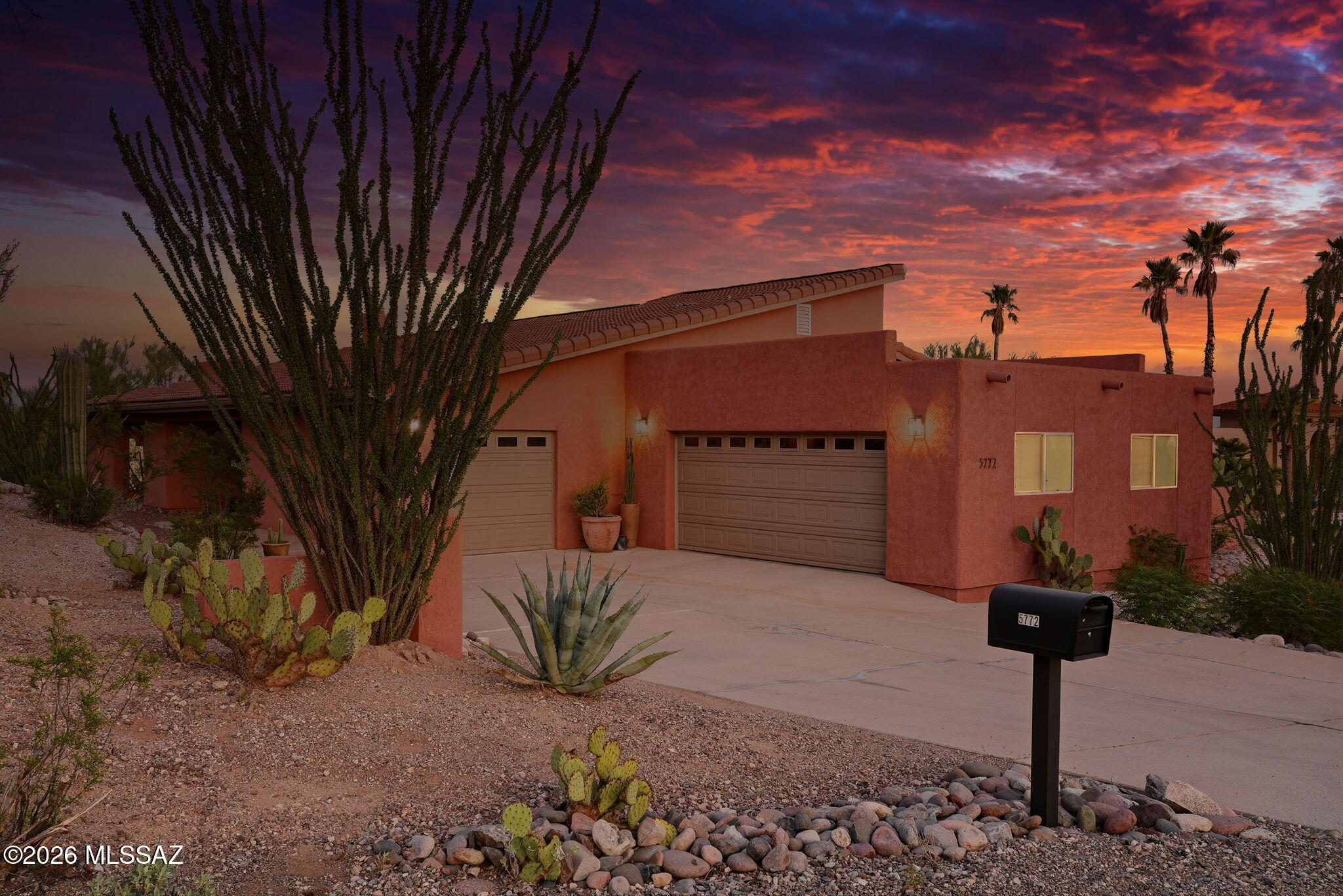 Enjoy the Arizona lifestyle in this thoughtfully designed Foothills home, ideally located near to shopping, restaurants, and hiking while offering a peaceful, secluded setting. The spacious backyard is designed for entertaining, featuring a sparkling pool with a natural rock waterfall, expansive flagstone patios, an outdoor fireplace, multiple seating areas, and a patio just off the kitchen for effortless outdoor dining. Desert landscaping and mountain, city, sunrise, and sunset views complete the setting. Inside, soaring ceilings create an open, airy feel, while the double-sided fireplace connects the living and dining spaces. The gourmet kitchen features a generous center island, oversized refrigerator and freezer, abundant cabinet space, and everything else needed for everyday living or entertaining.  The oversized primary suite is a true retreat, offering its own fireplace, a custom walk-in closet, and a beautifully appointed bath. Two additional spacious bedrooms, along with a three-car garage, complete this exceptional home.