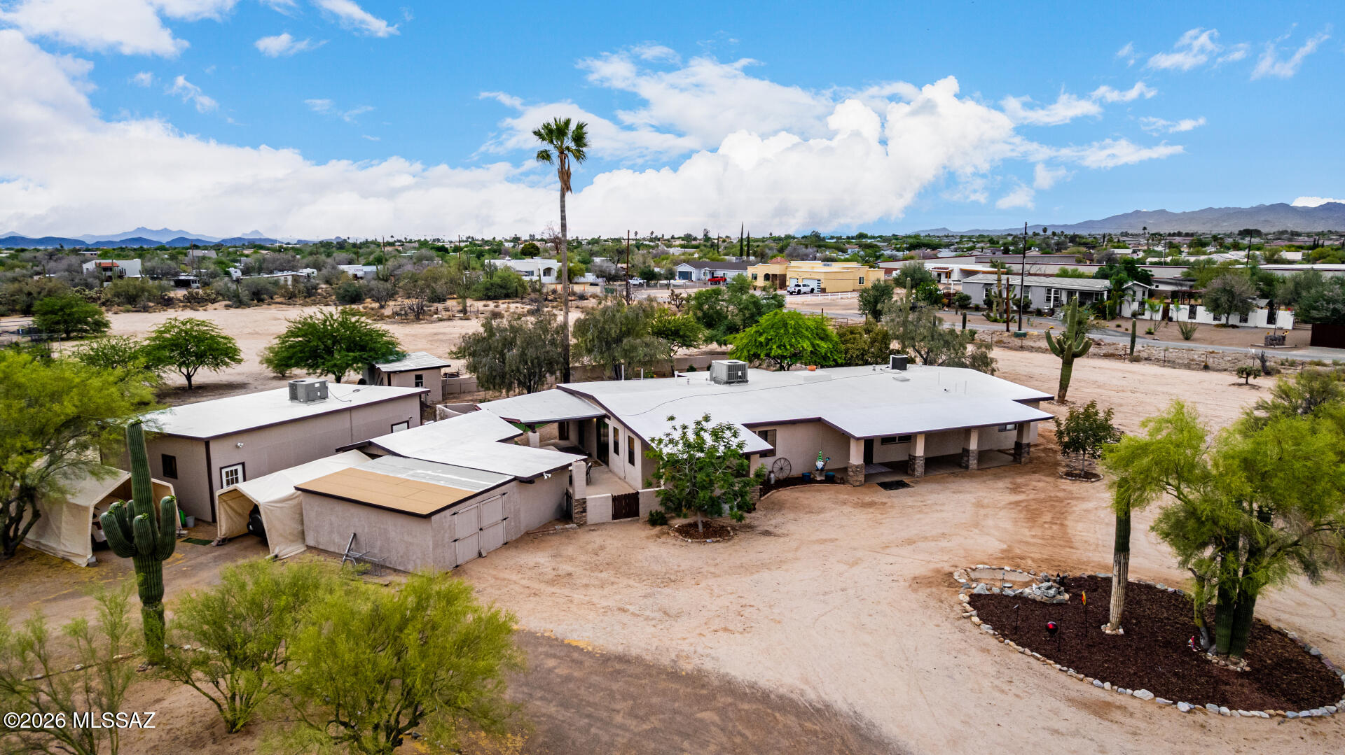 Exceptional acreage and opportunity in Northwest Tucson. Welcome to your ultimate 4.84-acre desert sanctuary, ideally positioned on the border of prestigious Oro Valley in the highly sought-after Northwest Tucson corridor. This rare multi-functional estate includes two contiguous 2.5-acre parcels and offers unmatched privacy, flexibility, and freedom with no HOA restrictions. Zoned SR, the property allows for animals, agriculture, and a wide range of uses, making it perfect for a home-based business, hobby farm, or future investment. A former 3-stall garage has been expertly converted into a professional-grade workspace with its own dedicated HVAC system, ideal for entrepreneurs, remote professionals, or creative studios, while two additional outbuildings provide generous space for equipment, workshops, or recreational storage. The second parcel offers incredible potential to build a custom home, guest house, or income-producing rental, or can be preserved as a private natural buffer. Enjoy breathtaking panoramic views of the Pusch Ridge and Catalina Mountains while being just minutes from shopping, dining, medical facilities, and top-rated schools. With room to park RVs, trailers, and more, plus a back lot ready for development, this property presents a rare opportunity for multi-generational living, investment, or simply embracing the desert lifestyle on your own terms.