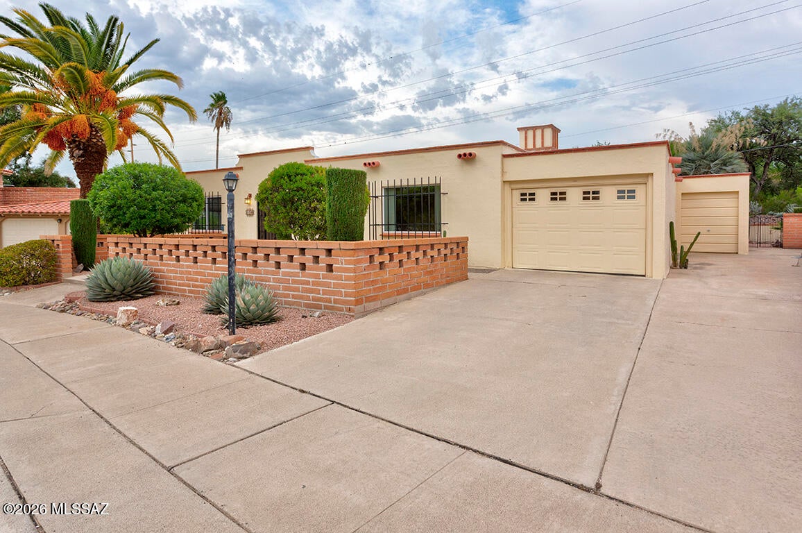 Superb location! Enjoy privacy and peaceful views from this well maintained home that backs to natural desert. Situated on an oversized lot in a large cul-de-sac, features include a front courtyard with a view of the golf course, large living room, great room with a corner brick fireplace and a fully finished Arizona room, providing plenty of space for relaxing and entertaining. Quiet, serene backyard with mature shade trees and no houses directly behind. So nice! Utility room with washer & dryer, sink, folding space and workshop area.  1 car garage plus a separate golf cart garage with space for storage or workshop. Close to shopping, golf, I-19 access and GVR center. A wonderful opportunity to enjoy Arizona living in an ideal location!
