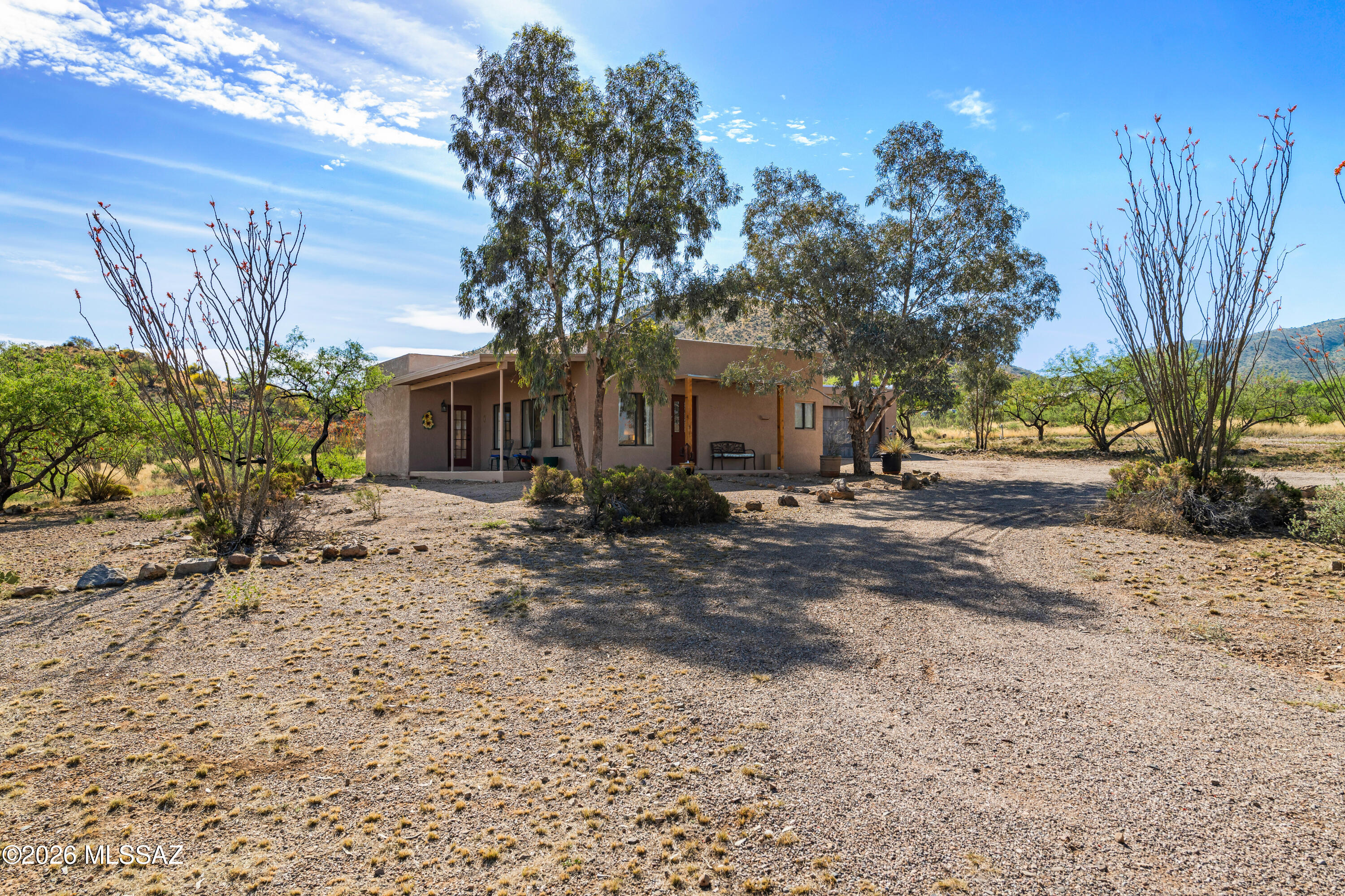 Owner/Agent. Small but elegant house in this Santa Rita foothills area on one of the nicest lots! Panoramic views of the entire Tucson valley to the north and beautiful Santa Rita mountains to the S & E. Great room off the kitchen has beautiful picture windows to enjoy the incredible views of the Tucson valley. Electro-static air filter for main house. Separate 400 sf studio off the detached double garage is heated and cooled with a half bath, offers many options (art studio, workshop, guest house, or anything else). New roof Sept. 2025 and new HVAC and water heater 5 years ago.  Exempt well has had new pump and casement installed 1 year ago. Complete RV hookup with cement pad. Small storage building that was built into the side of a hill was demolished due to poor condition. Seller will have a load dirt brought in and back fill it if Buyers do not want to rebuild a new structure in this unique spot. Large cargo container tucked away out of view for additional storage. Freshly painted inside and out. Ready to move in and begin to enjoy all the wonders of nature.