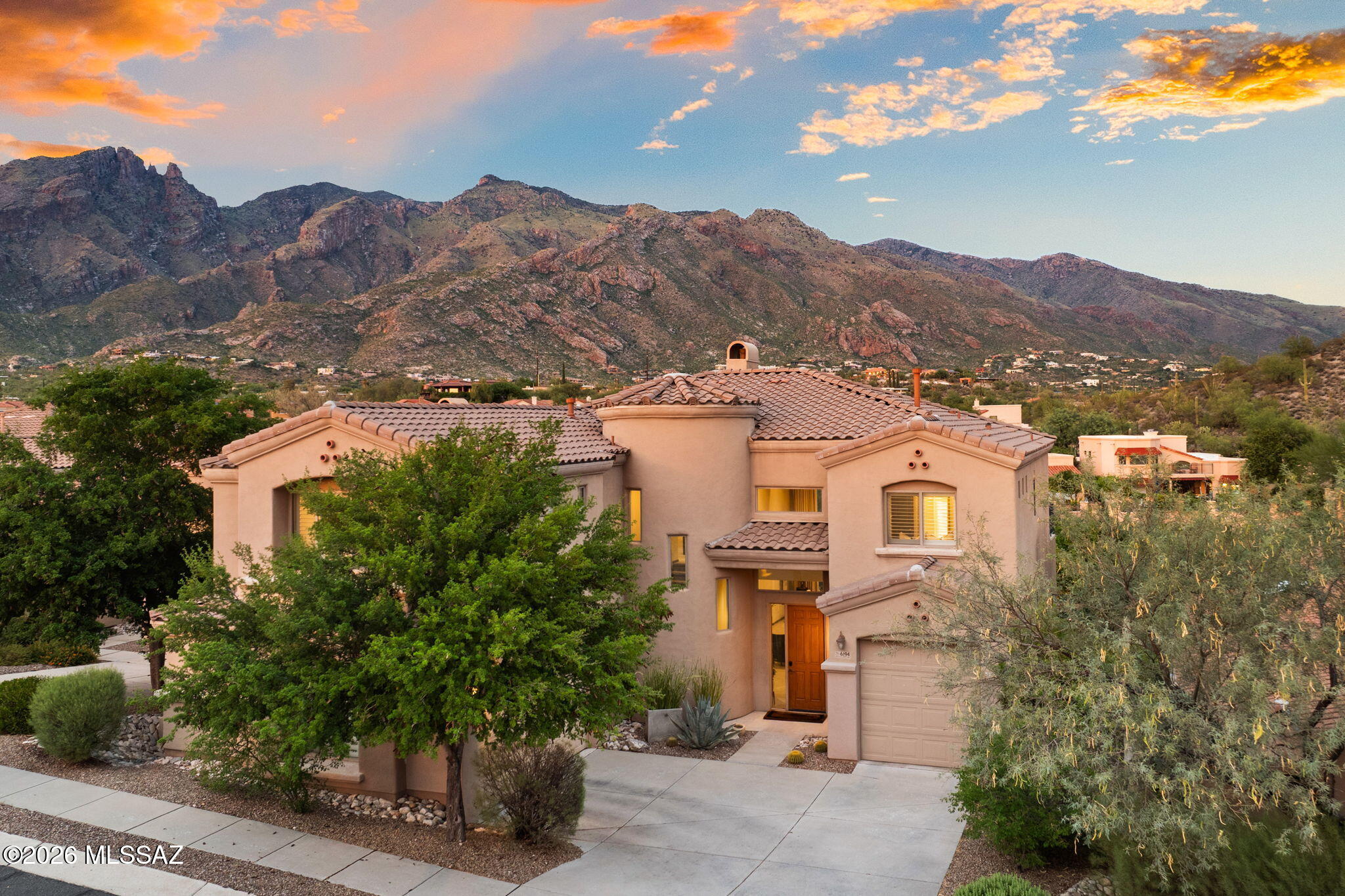 Discover your dream home in the prestigious La Paloma gated community, offering breathtaking mountain and golf course views. This residence welcomes you to a stunning great room and dining area with cathedral ceilings and elegant beams, seamlessly flowing into a custom-made bar that opens up for outdoor entertaining.  
The living room connects to a breakfast nook and kitchen, and leads to an inviting outdoor BBQ area.  The first floor also includes a sleek powder room and home office. 
Upstairs, the main master suite offers a private balcony, double vanities, a makeup area, a shower, a soaking tub, and a his-and-hers walk-in closet. A second master bedroom features a custom-made walk-in closet and a full bathroom with marble finishes, while two additional bedrooms share another full bathroom. Completing this home is a three-car garage, perfectly blending luxury with practicality in an idyllic setting.