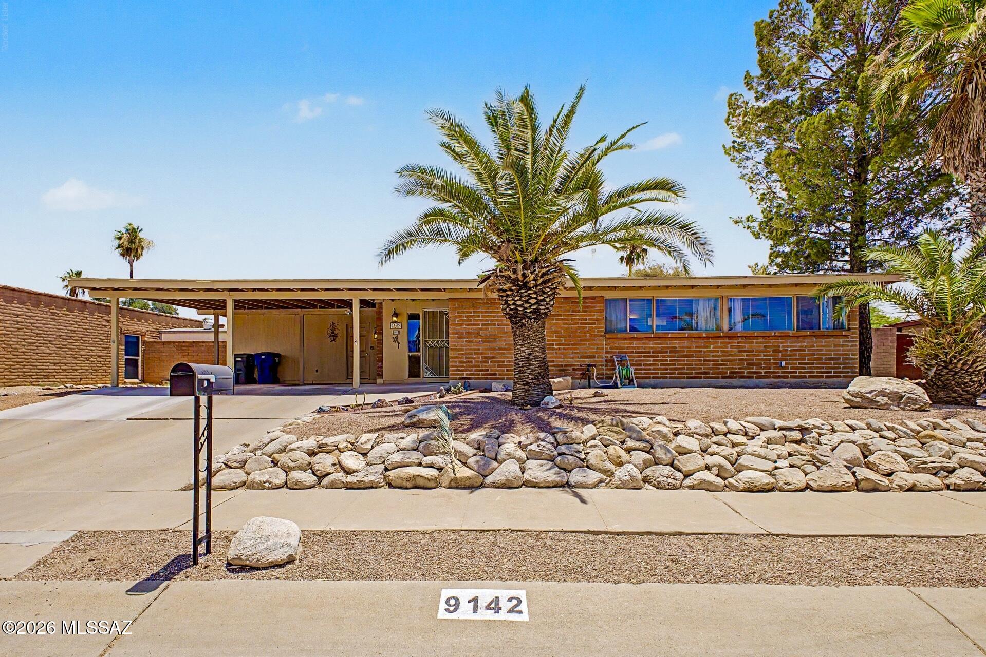 Fully furnished 3-bedroom, 2-bath home with a proven history as a successful vacation rental. Towering palm trees and established landscaping create exceptional curb appeal, while the private walled backyard offers a true Arizona retreat. Enjoy a sparkling pool with new heater and pump, a refinished built-in spa, artificial turf, and inviting outdoor living spaces designed for relaxing and entertaining year-round. Full-grown pepper trees provide abundant shade, while citrus trees add to the charm and character of the backyard setting. Inside, bright living spaces, tile flooring, and abundant natural light create a comfortable atmosphere. Whether you're seeking a full-time residence, winter getaway, or turnkey investment property, this Tucson gem is ready to enjoy from day one. Ideally located near Saguaro National Park and other outdoor recreation opportunities, it offers the best of the Tucson lifestyle.
