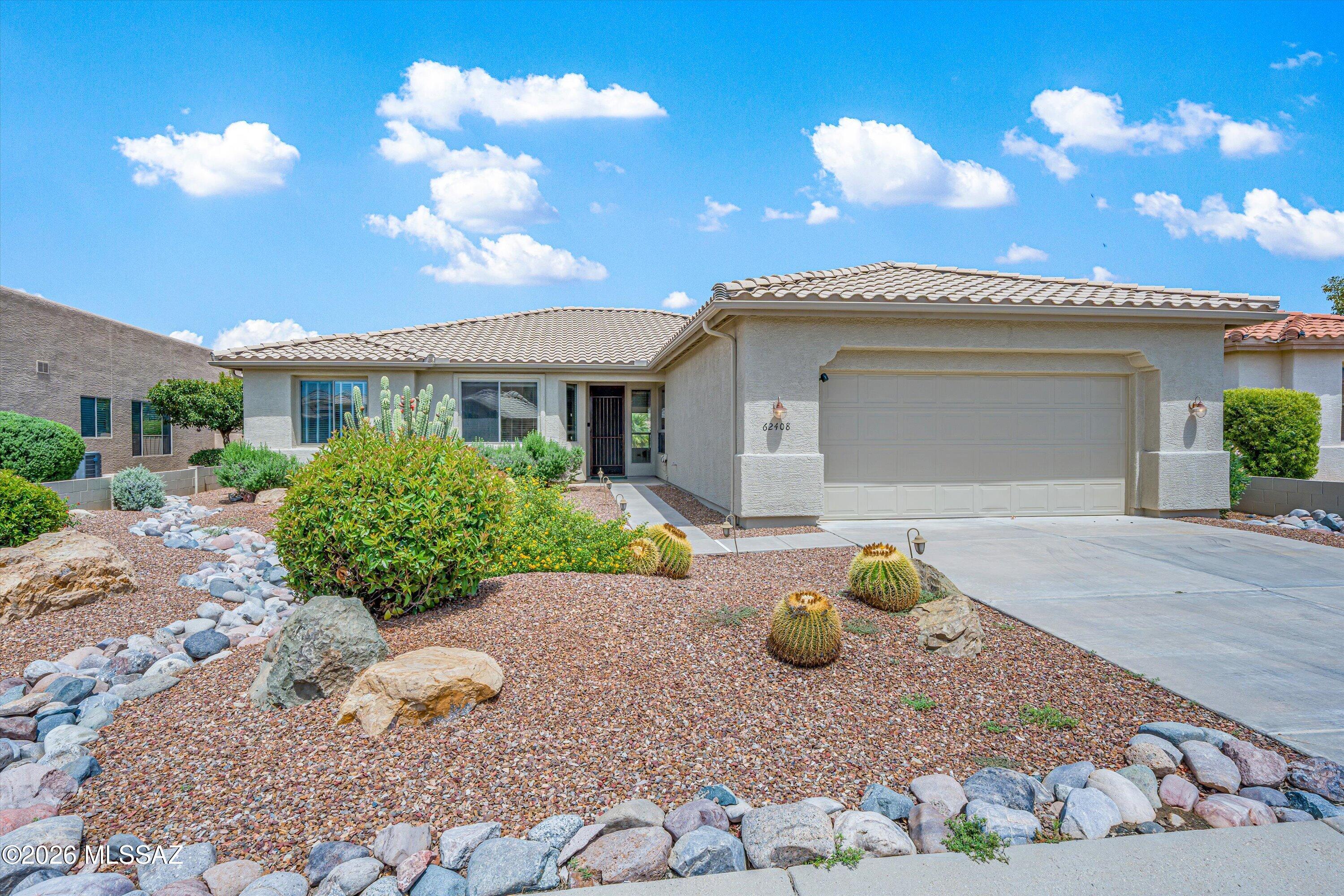 Welcome to the highly desirable Cimarron model with open floorplan concept and all new roof underlayment. Step into a bright, open great room filled with natural light, expansive backyard views, and refined coffered ceilings that create an impressive yet welcoming atmosphere. The thoughtfully designed island kitchen is both beautiful and practical and makes entertaining effortless, with a large passthrough, generous island, abundant cabinetry, double pantry, granite counters, and a charming nook overlooking the landscaped front yard. A versatile den with built-ins offers ideal flexibility for work, hobbies, or relaxation. The primary suite offers a peaceful escape with an en-suite bath, dual vanities, a large shower, and a roomy walk-in closet, while the gues bedroom and bath provide comfort for your visitors making hosting easy. Outside, the covered paver patio, extended hardscape, golf course views, and natural common area invite you to relax, entertain, and take in the golf course and natural common-area views creating an exceptional setting for outdoor living that exemplifies the SaddleBrooke lifestyle and the beautiful natural surroundings.