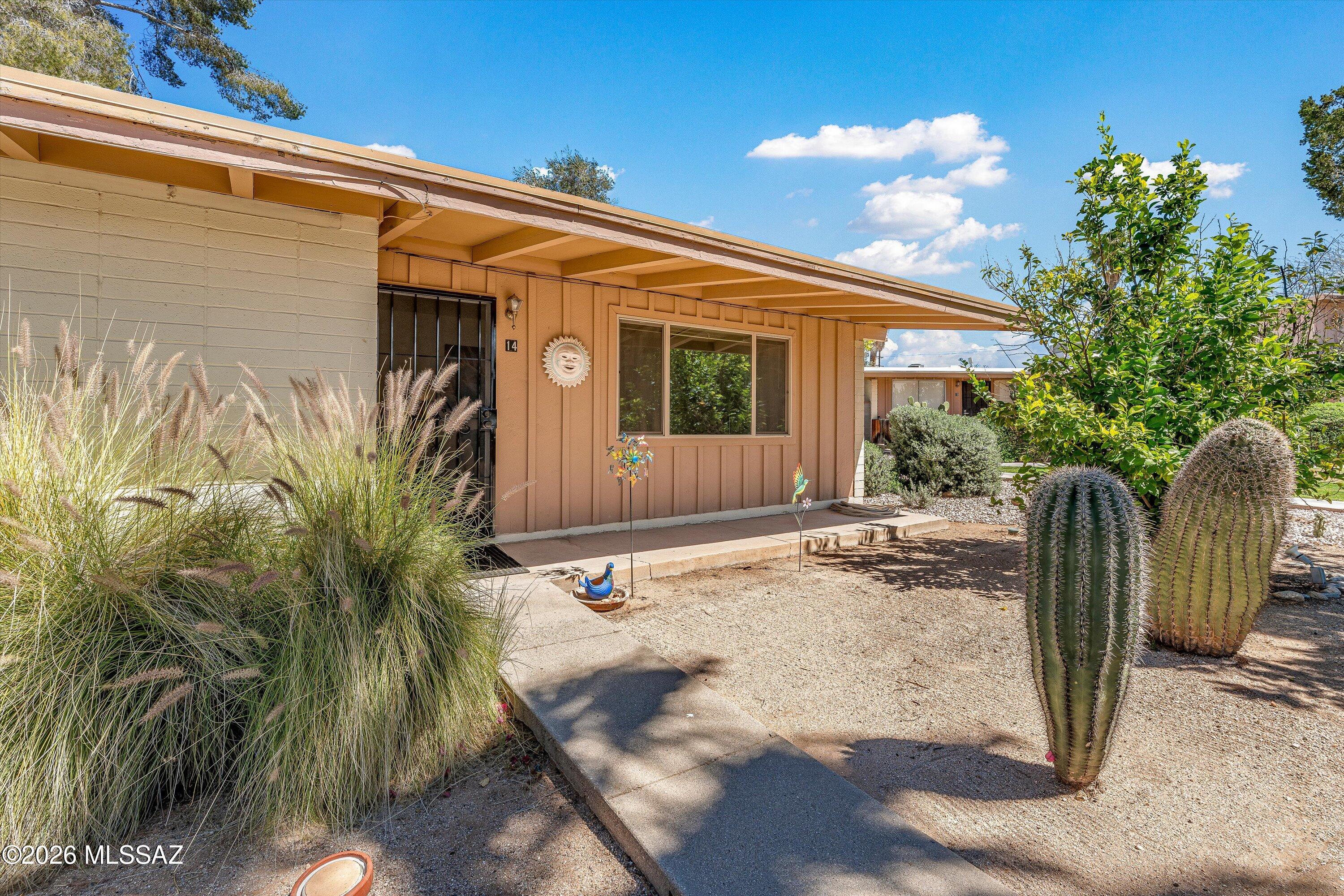 Mid-century charm meets modern updates in this move-in ready end-unit condo at 5901 N Oracle Rd #14. Thoughtfully renovated with laminate flooring, updated lighting and fixtures, dimmable recessed lighting, and a stylishly remodeled bath. Kitchen features updated stainless steel appliances and newer cabinets. Functional layout with no interior steps, no upstairs neighbor, and in-unit washer/dryer combo. Enjoy a private patio and covered carport parking. Set within a beautifully maintained, garden-like community with a grass park, desert plants, trees, covered ramada with BBQ, and a stunning pool with island. Ideally located near Tucson Mall, restaurants, medical services, and easy access to Tucson and Oro Valley.
