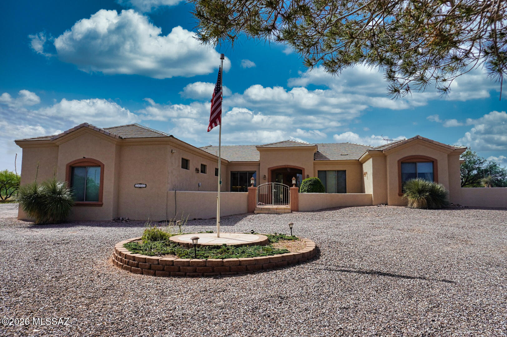 Perched high on a scenic Elevated 10 acre parcel in Benson, this meticulously maintained Modern Santa Fe style home backs up to State Land on 2 sides! This property offers an exceptional blend of privacy, quality construction, and breathtaking Panoramic and Mountain views. The property is fully fenced and gated with a long, private  and paved driveway leading to a truly special retreat. 
Step inside to find a welcoming foyer, large great room, wood burning fireplace, lots of windows,  a neutral color pallet and vaulted ceilings. The home is constructed from insulated concrete ''Rastra Block''  and is finished with a durable stucco exterior and ceramic tile roof, this home is designed for lasting comfort and efficiency. Outside there are large covered patios facing both east and south-idea for enjoying vibrant sunrises, cool shaded afternoons, and peaceful desert evenings. The patios have been upgraded with a professional epoxy textured coating, adding both beauty and durability to your outdoor living spaces. 
Equestrian enthusiasts will appreciate the horse facilities including tack and feed room, horse shelter for 2 and direct access to adjacent state land, complete with a private gate--offering endless opportunities for riding and exploring right from your own property!
Additional highlights include an oversized two-car garage, Plus a third detached workshop/garage, meticulous upkeep home throughout, and a setting that delivers unmatched tranquility, space, and wide-open skies. Home has a private well with excellent drinking taste without being filtered. 
If you're seeking privacy, views, access to state land and the ultimate Arizona lifestyle, this one-of-a-kind property is not to be missed!