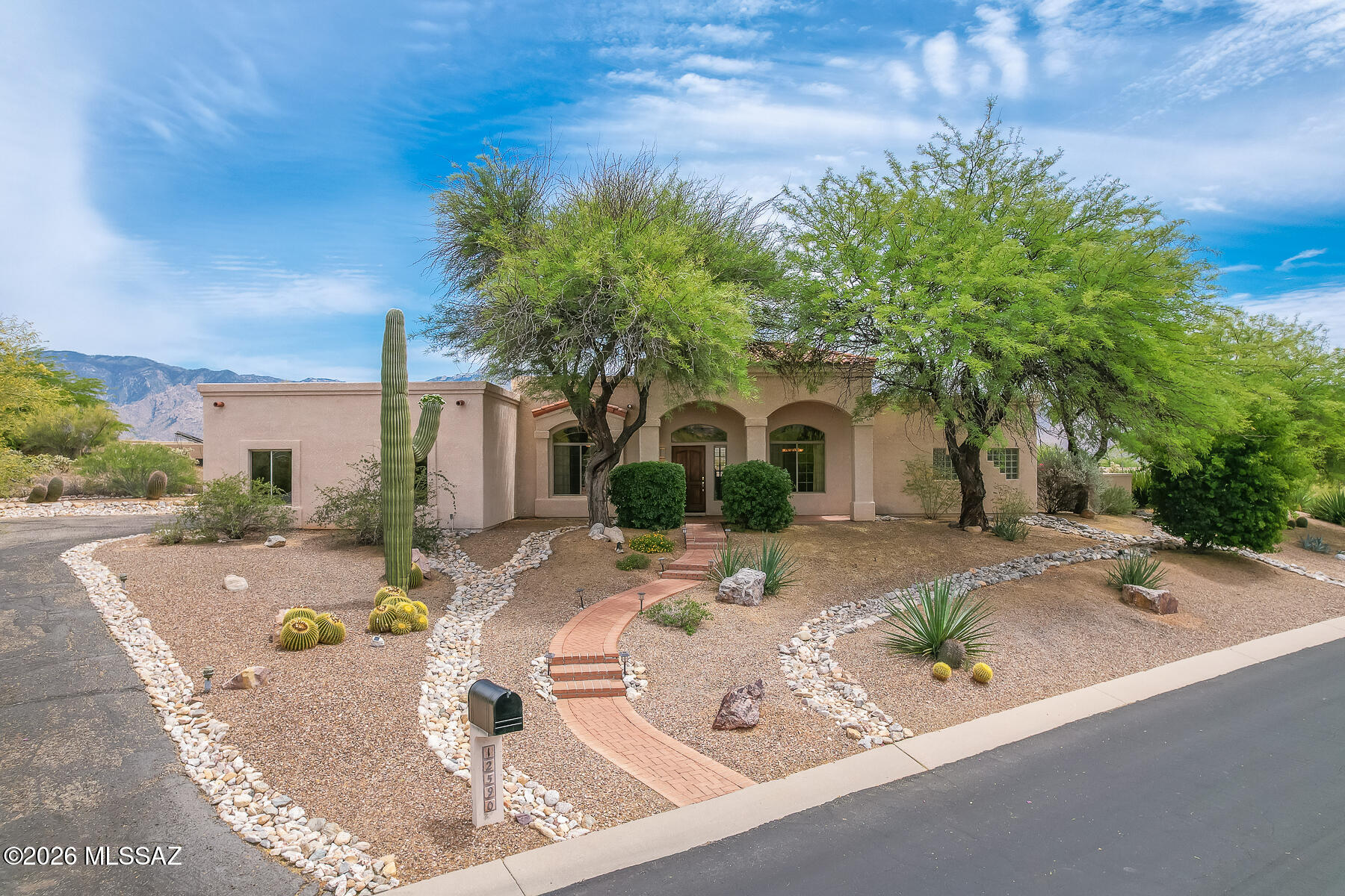 Welcome to your own private (3BD/2.5BA 3,021sqft) estate in the prestigious heart of Oro Valley at Rancho Vistoso! Perched on a sprawling half-acre corner lot, this magnificent home offers a rare combination of desert privacy and some of the most dramatic, ''front-row'' views of the Santa Catalina Mountains and Pusch Ridge in all of Oro Valley. From the moment you pull up the long, private driveway, you'll appreciate the classic Southwest charm and professional desert landscaping. Inside, the home opens to a bright and expansive floor plan featuring high ceilings and large picture windows designed to bring the mountain beauty indoors. The heart of the home is a spacious kitchen with a center island and breakfast bar that flows effortlessly into the great room--perfect for hosting large gatherings or enjoying quiet desert evenings by the fireplace. The primary suite is a true getaway, offering a private exit to the patio and a spa-like bath with a soaking tub, dual vanities, and a generous walk-in closet. The split-bedroom design ensures plenty of privacy for guests or family members, while the formal living and dining areas provide an elegant space for more refined entertaining. Step outside to experience a backyard oasis that is second to none. The deep, full-length covered patio leads to a sparkling pool and spa, all framed by the rugged beauty of the Catalina Mountains. With over a half-acre of land, you have the ultimate buffer of space and tranquility. Complete with a 3-car garage and proximity to golfing, shopping, and so much more! this is the Arizona lifestyle you've been dreaming of!