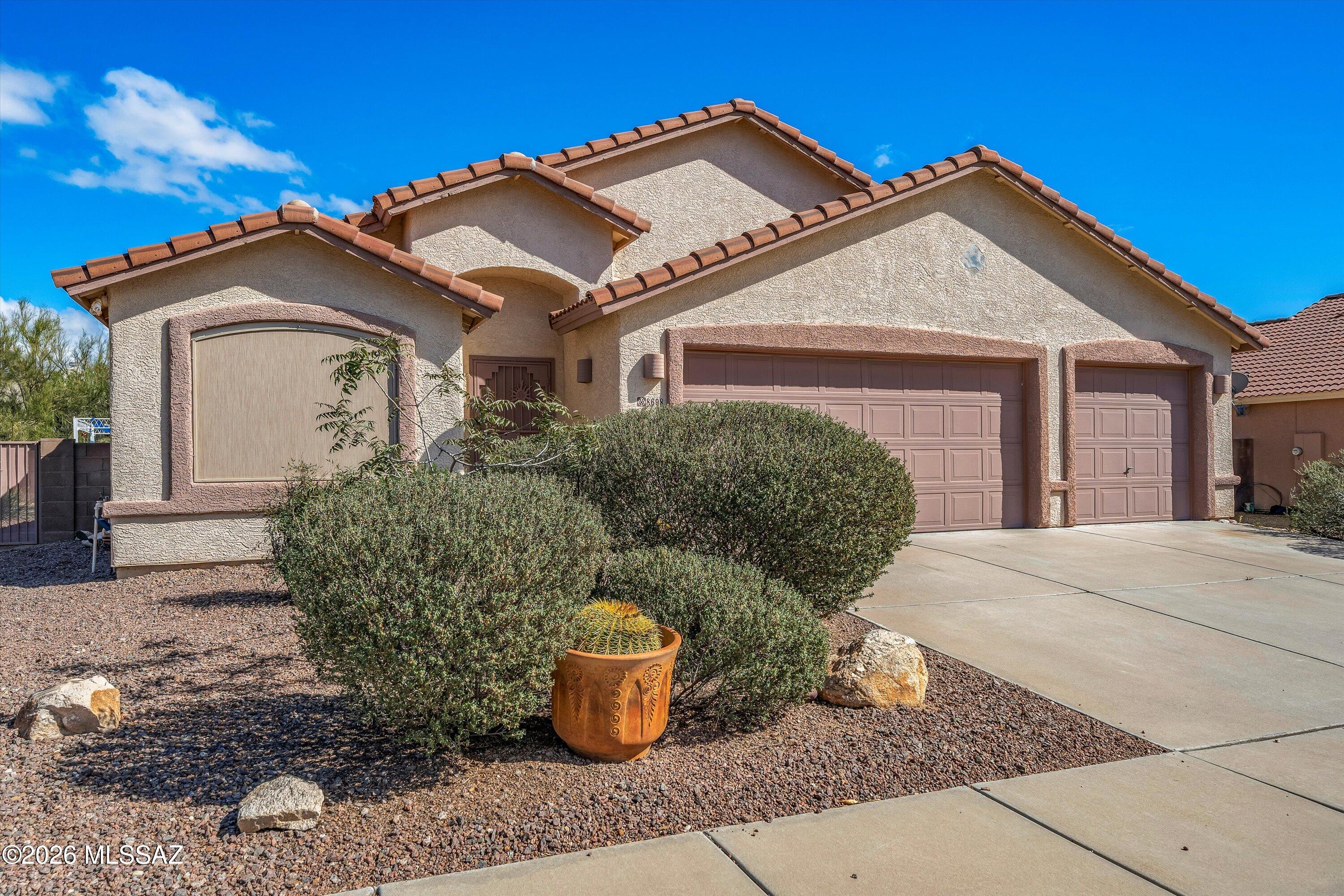 This recently upgraded home located in a small, quiet subdivision on the Northwest side features new carpet in all bedrooms, newer plank tile + new grout, new doors, and fresh interior paint and new baseboards throughout. The kitchen stands out with quartz countertops, island w/breakfast bar, newly painted cabinets, oversized sink, and stainless steel appliances. The vaulted ceilings, two-way open and close Hunter blinds, newer LED ceiling lights in the great room, and large windows make the home bright and airy. The fourth bedroom has double doors and a beautiful stained glass window that make it an ideal office. The large 3-car garage has two newer Liftmaster openers with Wi-Fi enabled, epoxy floors, plus fresh paint and baseboards. Sliders open from the great room to the private covered patio, which backs up to natural desert. The neighborhood park and basketball court is just steps from your front door. See complete list of features and upgrades in documents. Owner/Agent.