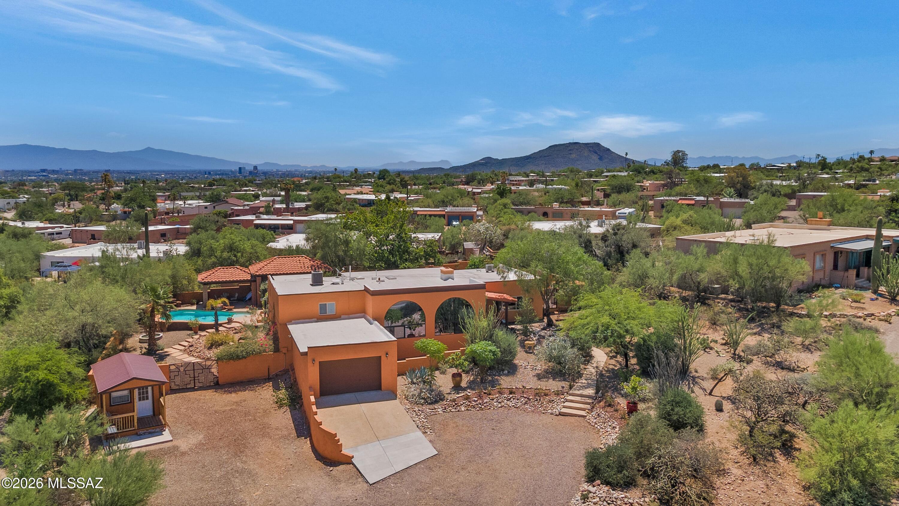 Welcome to this beautifully updated 3-bedroom, 2-bath home in a highly desirable west-side location with no HOA! Conveniently located near shopping, downtown Tucson, and Pima Community College, this property offers the perfect blend of comfort, convenience, and Arizona outdoor living.

Situated on approximately 1/3 of an acre, this exceptional property showcases breathtaking Tucson Mountain views and unforgettable Arizona sunsets. The beautifully landscaped backyard is a true private oasis, featuring a sparkling swimming pool, an outdoor fireplace, and a spacious gazebo with a fully equipped bar area--perfect for entertaining family and friends year-round. Inside, you'll find a remodeled kitchen with granite countertops, updated bathrooms, and a warm, inviting floor plan. 
Major system updates include an approximately 2-year-old HVAC system and water heater, providing added peace of mind. A newly built outdoor workshop offers additional space for hobbies, storage, or projects.
This is a rare opportunity to own a move-in-ready home with incredible indoor and outdoor living spaces in one of Tucson's most convenient west-side locations.
Need room for your toys?  This property also offers RV parking making it ideal for RV owners, outdoor enthusiasts, or guests.