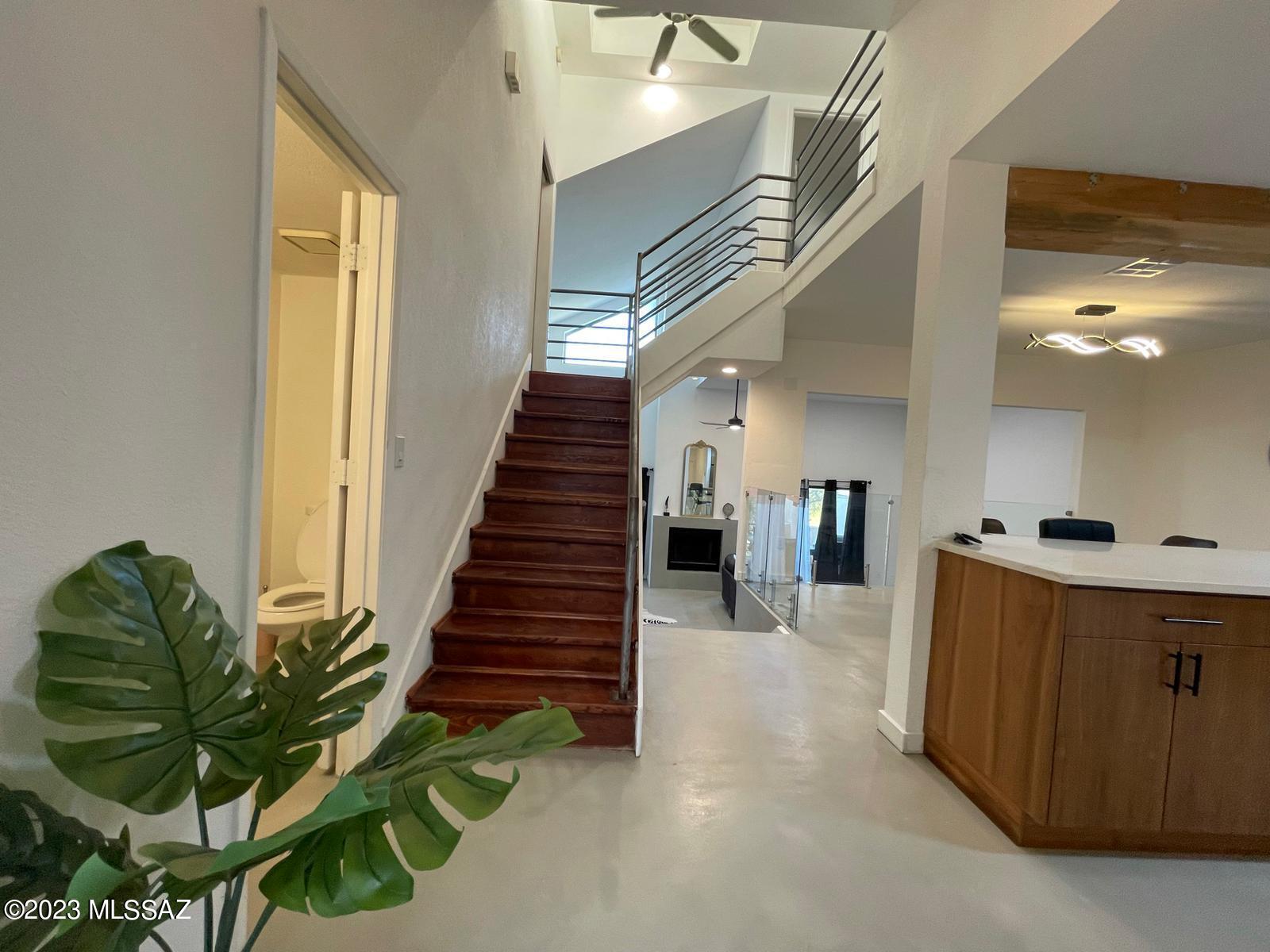 Fully furnished! Completely remodeled townhome in unique community of Mescal Place in the foothills. Contemporary open floor plan with concrete overlay, high end finishes, new kitchen with quartz countertops, all new fixtures and recessed lighting.  Patio and deck and balcony overlooking the Catalina mountains.  2 car garage with two master bedrooms with Community pool and spa.