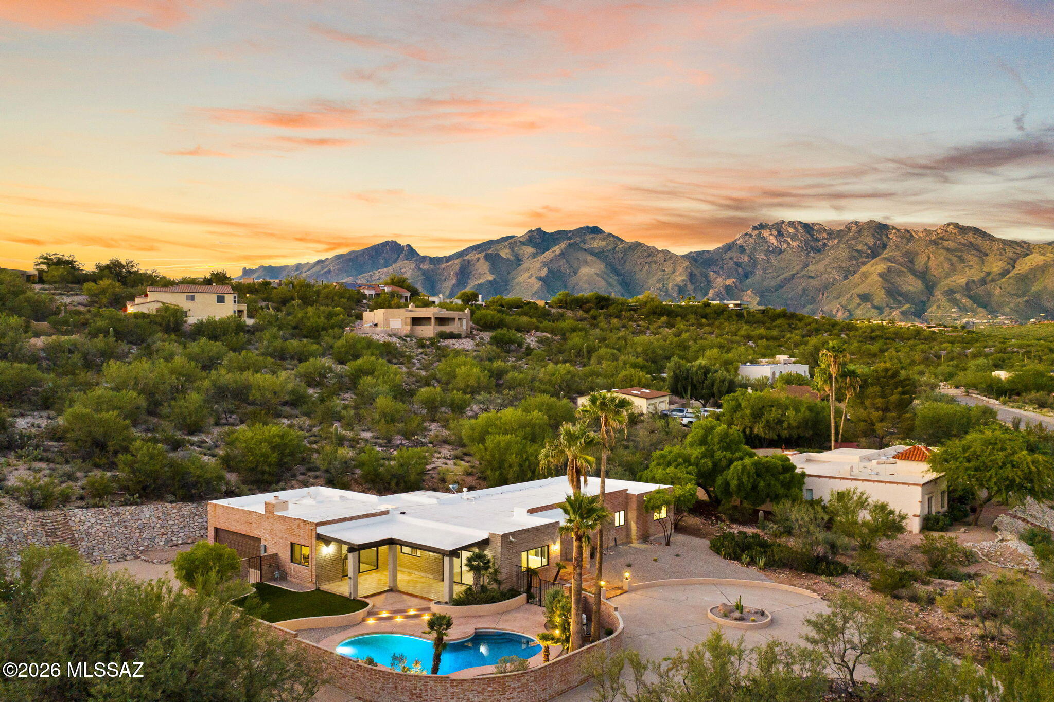 Stunning fully renovated home near River & Craycroft with breathtaking city views and exceptional indoor-outdoor living. Thoughtfully redesigned from top to bottom while preserving its warm Southwestern character, featuring exposed wood ceilings, a statement fireplace, beautiful wood flooring and a showstopping kitchen with high-end appliances and designer stone. Enjoy two separate yards, a completely renovated pool and multiple spaces to take in the views. Extensive upgrades include new HVAC, windows and doors. A truly special Tucson home where elevated design meets timeless desert charm. Owner/Agent