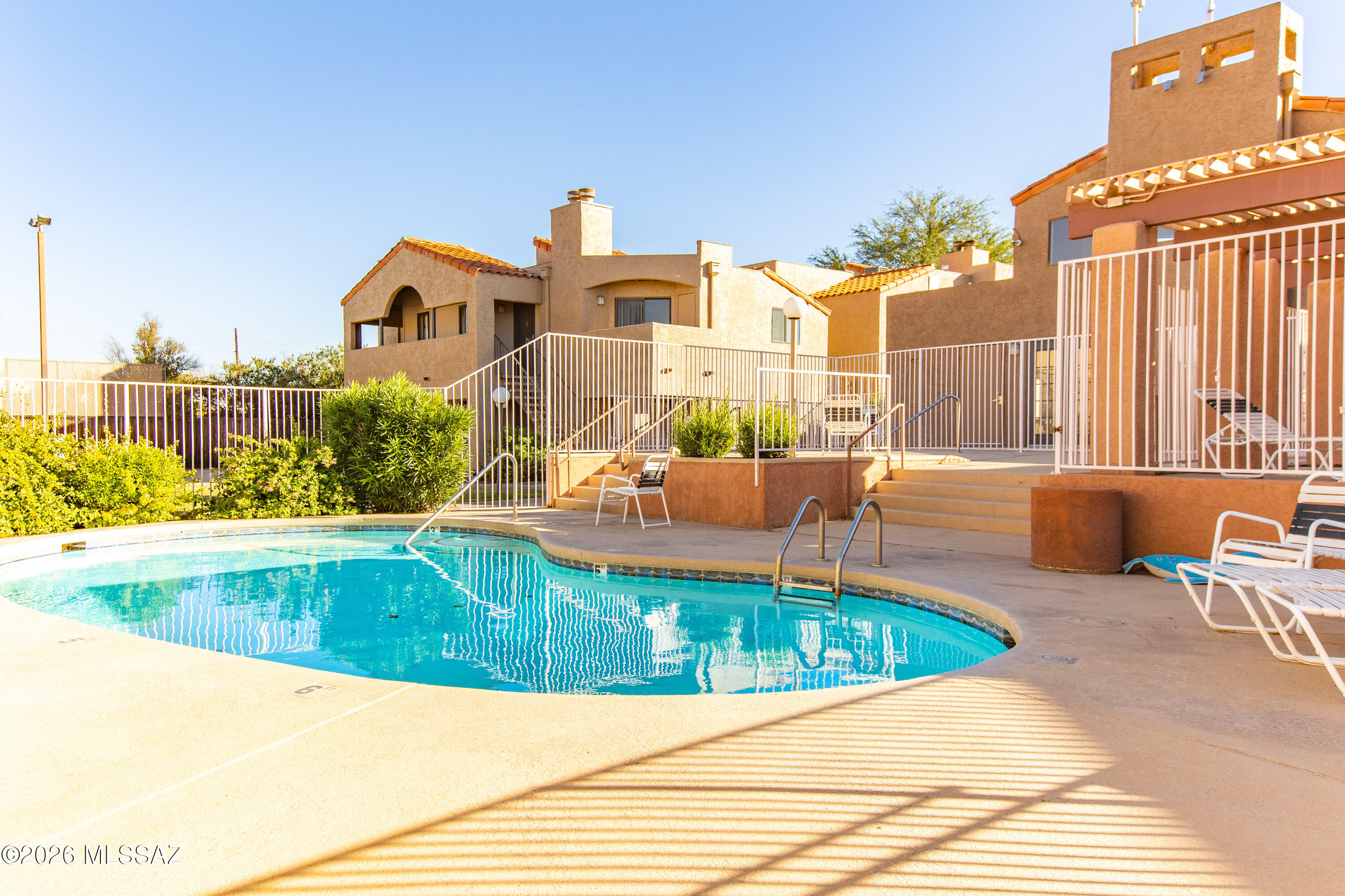 Range Priced-Seller will accept/or counter offers b/w $150,000 &/or $155,000. Welcome to this bright 2BD/1BA upstairs condo in a serene gated community! Abundant natural light fills the living space, creating a warm & welcoming retreat. Enjoy large bedrooms, a well-appointed kitchen, a dedicated dining area, Vaulted ceilings, hardwood floors, and a private balcony for relaxing outdoors. Community amenities include a sparkling pool, soothing spa, fitness room, BBQ, basketball court, and clubhouse & the HOA covers fire protection, trash, termite/pest, water/sewer, roof, & all amenities. All of this PLUS a perfect location close to the U of A, Banner Hospital, downtown, shopping, restaurants, bike paths, transit lines & entertainment. Visit today and discover easy living!