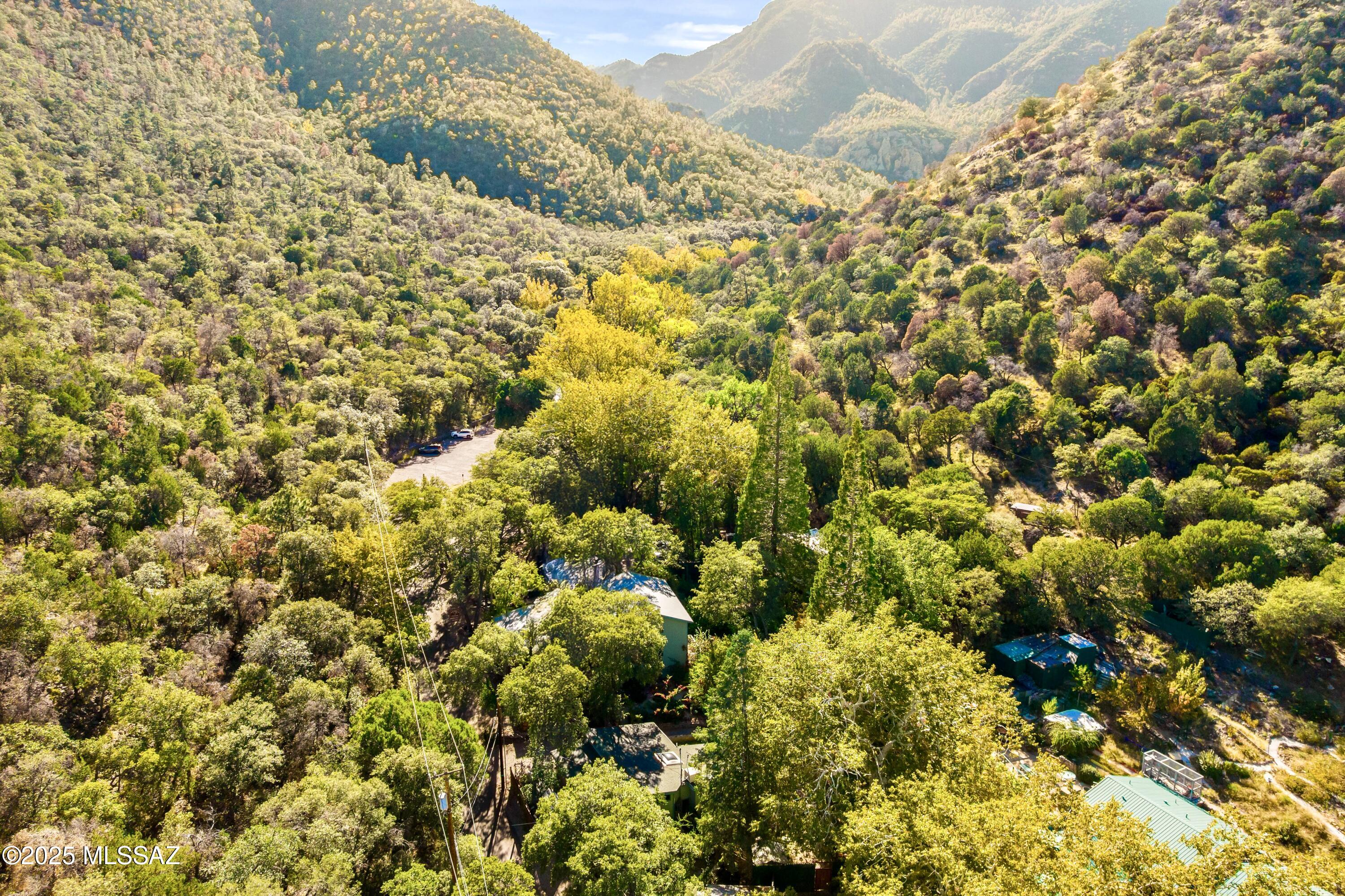Sale includes parcel #105-46-005S (land only) and is a child listing to MLS # 6942021. Over 5 acres, 2 homes, and room to develop! This property features 2 homes and over 4 undeveloped acres with water access. The first is a single family style with 2 bedrooms, 1.5 baths, full kitchen, double stacked laundry units, covered patios, running pond complete with fish, private courtyards and more. This place is plain good vibes, making you feel like your getting away from it all! The original stone walls are not only beautiful but also impressive. The second structure is a triplex style. The first floor offers two suites. Each suite has a condensed kitchen/dining area, living area, private bedroom with en suite bathroom. The second floor offer one expanded suite with full kitchen, dining and living room areas, private bedroom with large en suite bathroom. The bathroom offers a tub/shower combo with a walk through closet.This property offers the flexibility of living in one structure and creating income in the second structure or generational living where everyone is in reach but still has privacy! Great flexibility to customize to your needs!
Besides the amazing residences, this property also features 4 acres of land with water access that could be further developed. Enjoy the bird blind towards the high end of the parcel to watch nature close up and personal! The hummingbirds are breathtaking. There is also an expansive paver patio area with a custom bar/gazebo. This patio area is a retreat ensconced in nature, features string lights that add a whimsy touch at night. Don't forget the seasonal running creek! It is a true delight! Nature, wildlife, mature fruit trees and bushes cover this land. Take it all end!