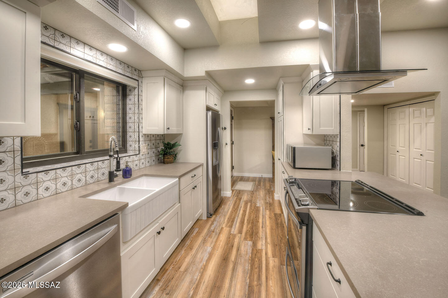 DON'T MISS OUT on this 2BD, 2BA townhome in the Foothills! Experience luxury living w/fabulous kitchen remodeled and featuring high end stainless appliances, white shaker style cabinets, quartz countertops, custom tiled backsplash, and designed to be bright and open with lots of natural light! Kitchen opens to expansive great room featuring high ceilings and a gas fireplace! Next to the kitchen is a room that could be a large formal dining room or separate den! The professionally landscaped backyard is low maintenance w/beautiful pavers, artificial grass & drought tolerant plants that thrive in Tucson climate! The patio offers amazing views day & night!
